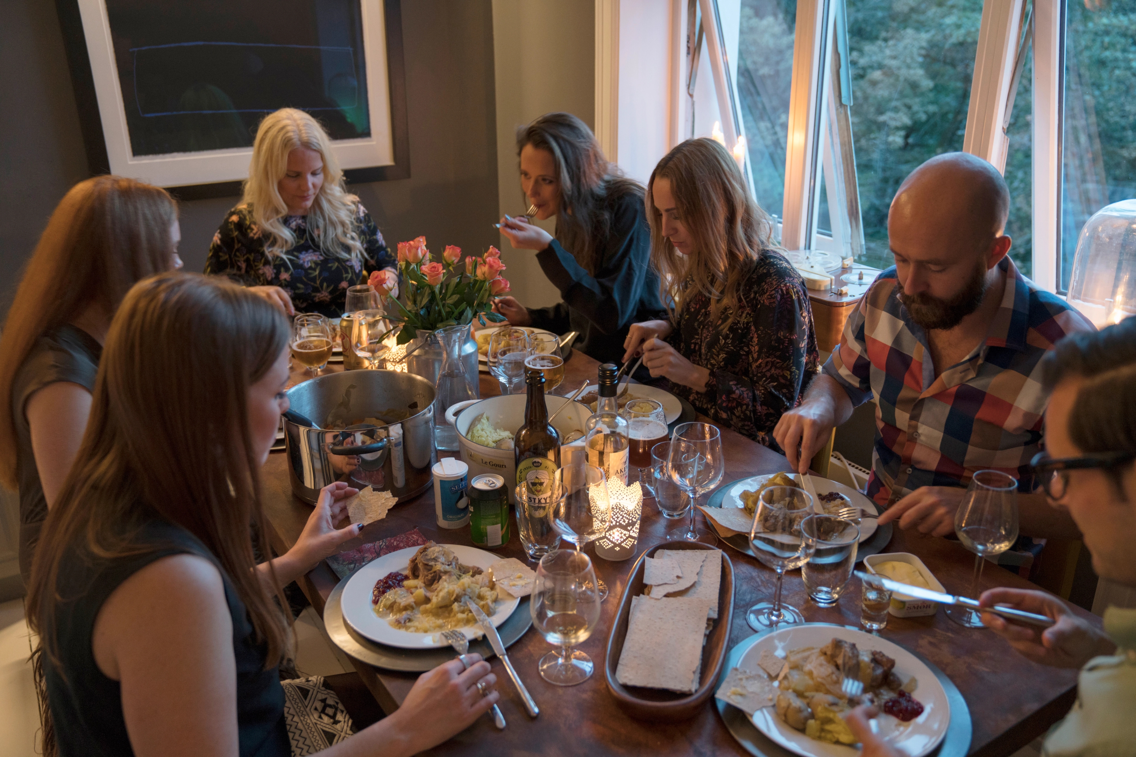People around a dinner table eating fårikål lamb stew in Oslo, Eastern Norway