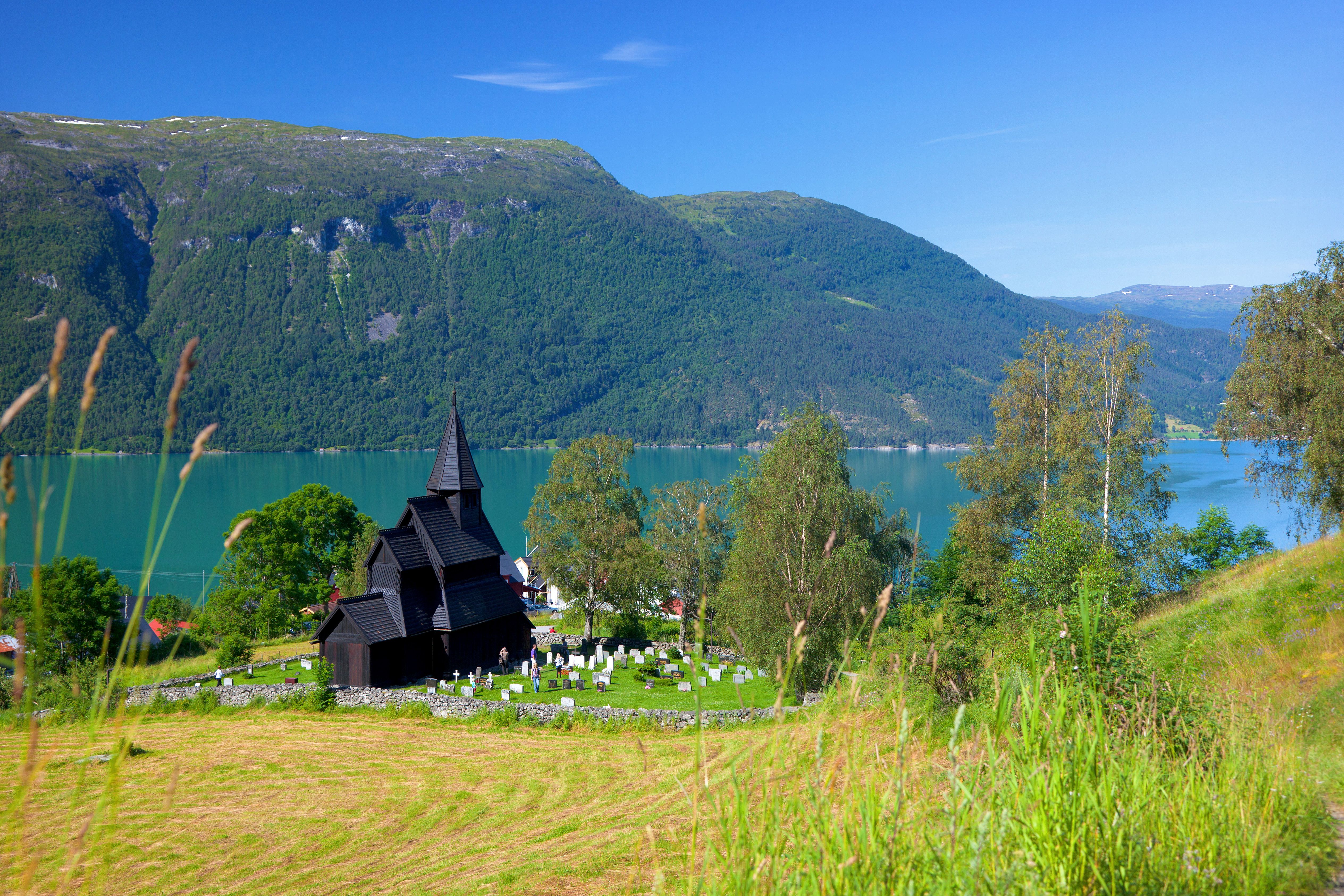 The stave church by the fjord in the lush summer in Urnes, Fjord Norway