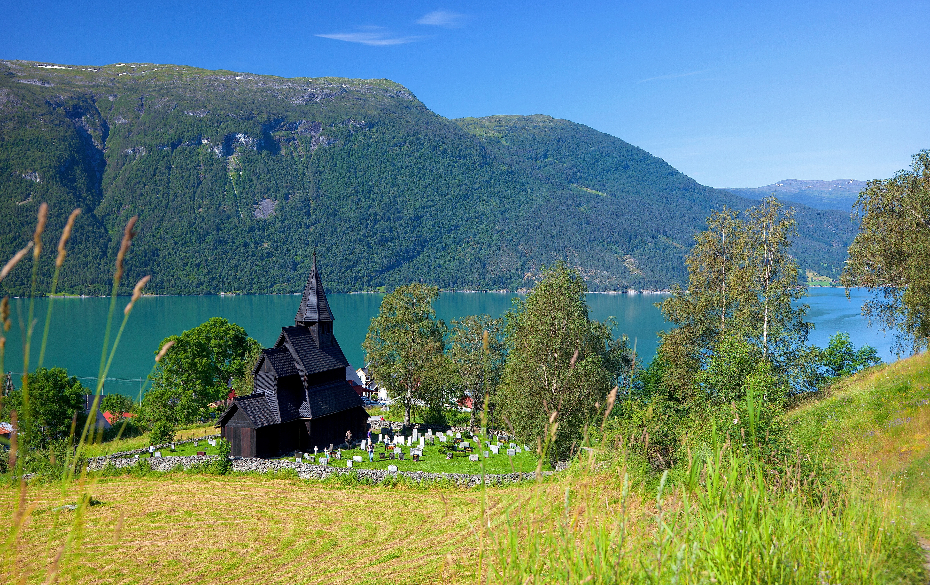 The stave church by the fjord in the lush summer in Urnes, Fjord Norway