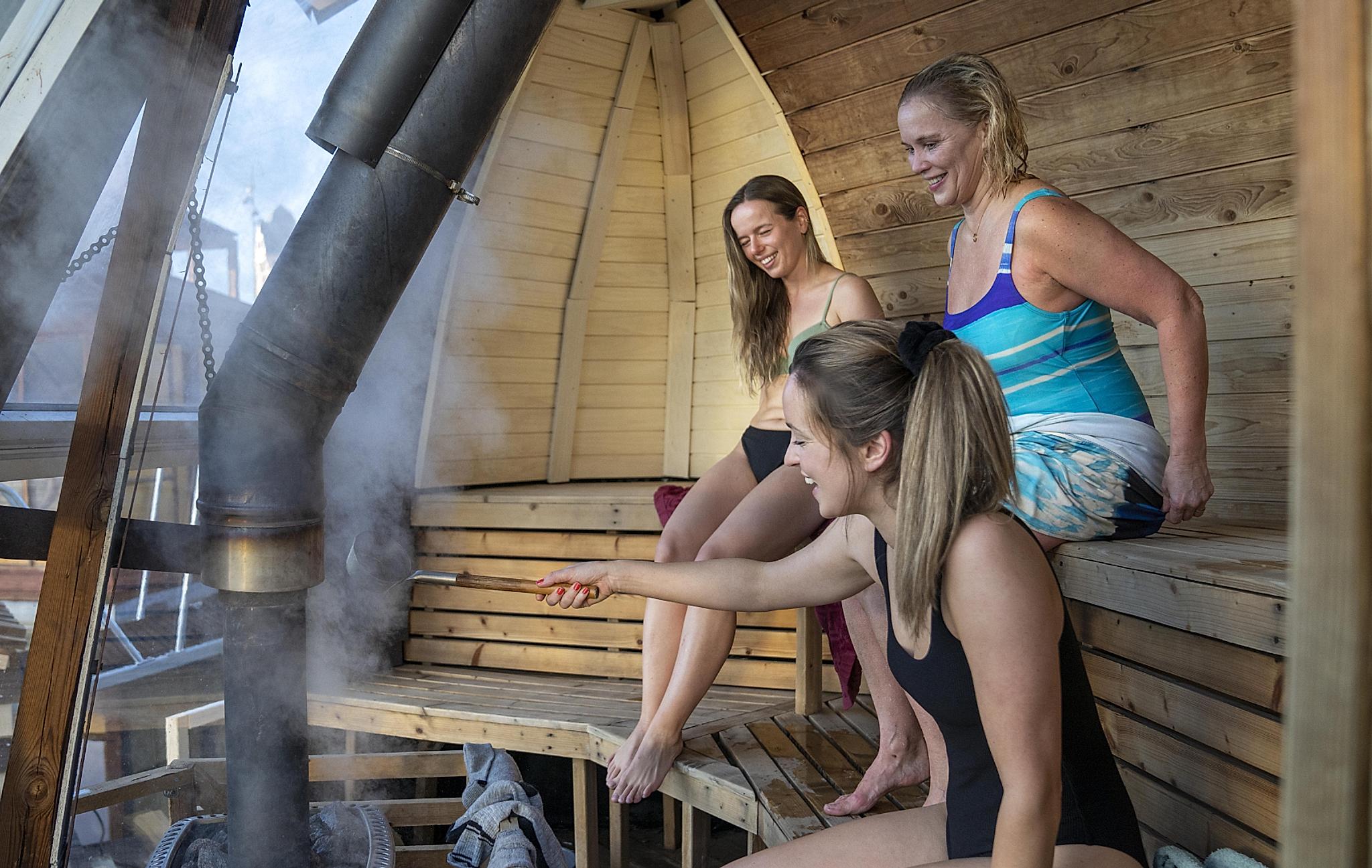 Friends sitting in Sauna at Oslo Badstuforening in Oslo, Eastern Norway