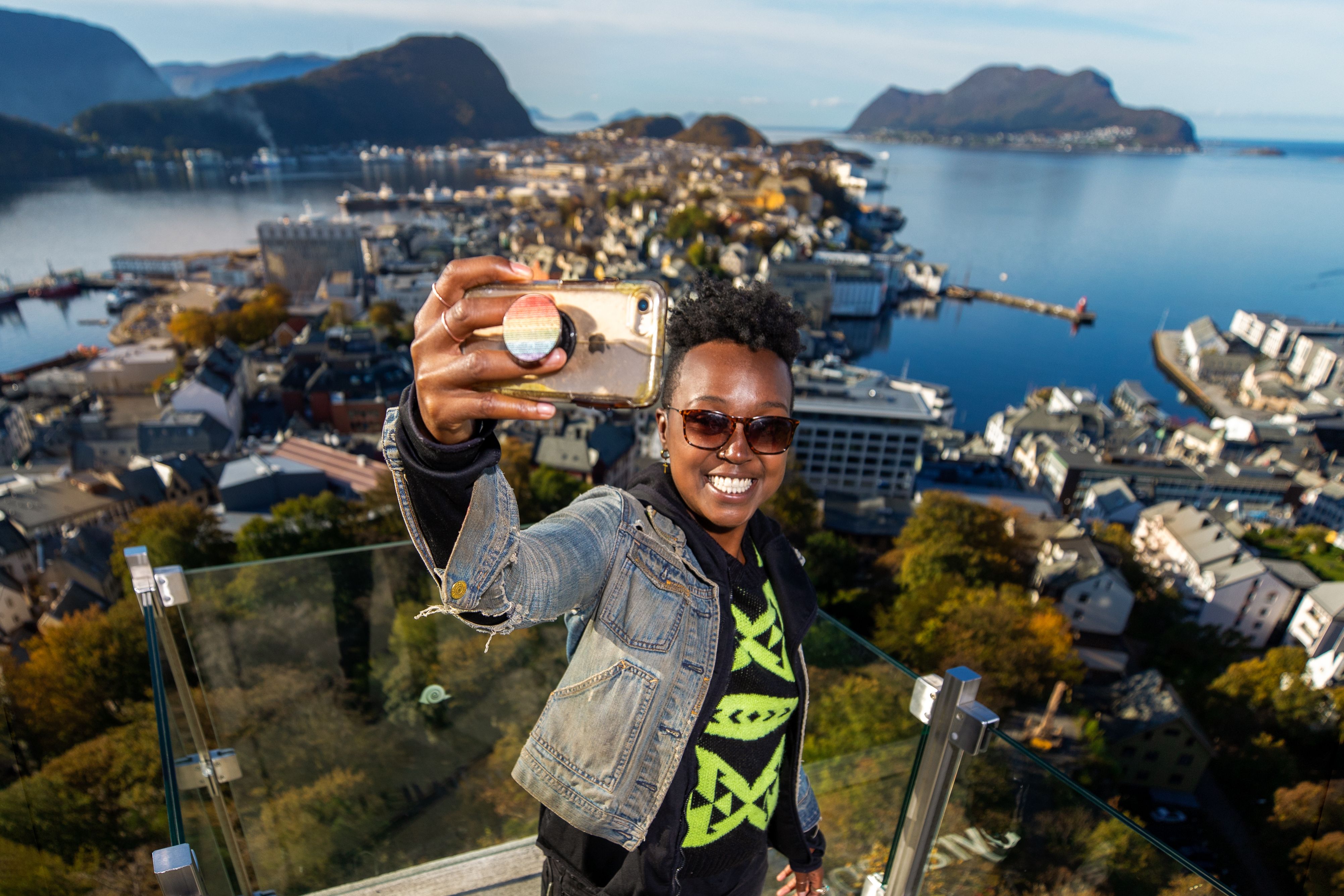 A woman taking a selfie at Aksla in Ålesund, Norway