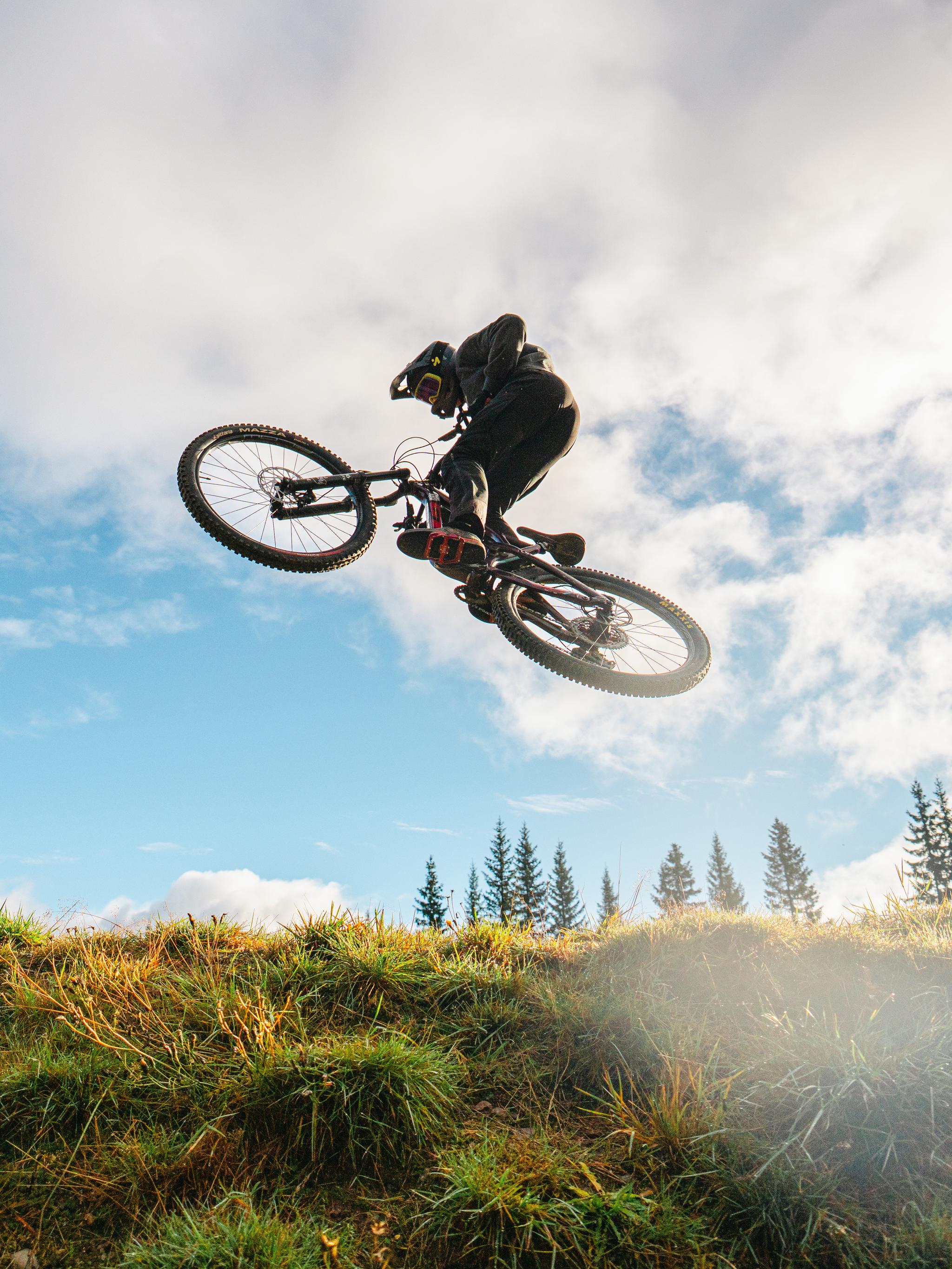 A boy on a bike in mid-air.