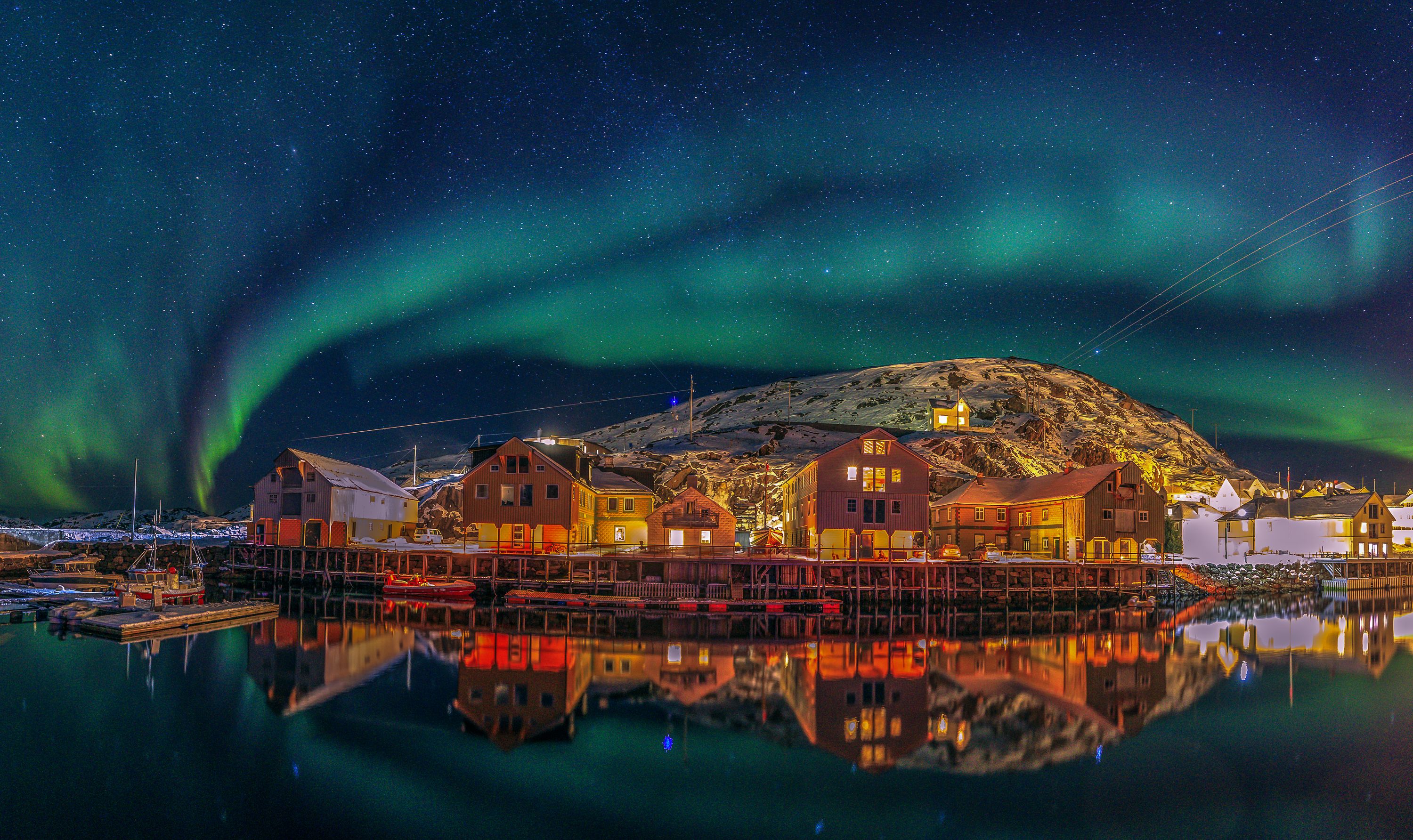 Fisherman's cabins under the northern lights in Nyksund in Vesterålen, Northern Norway