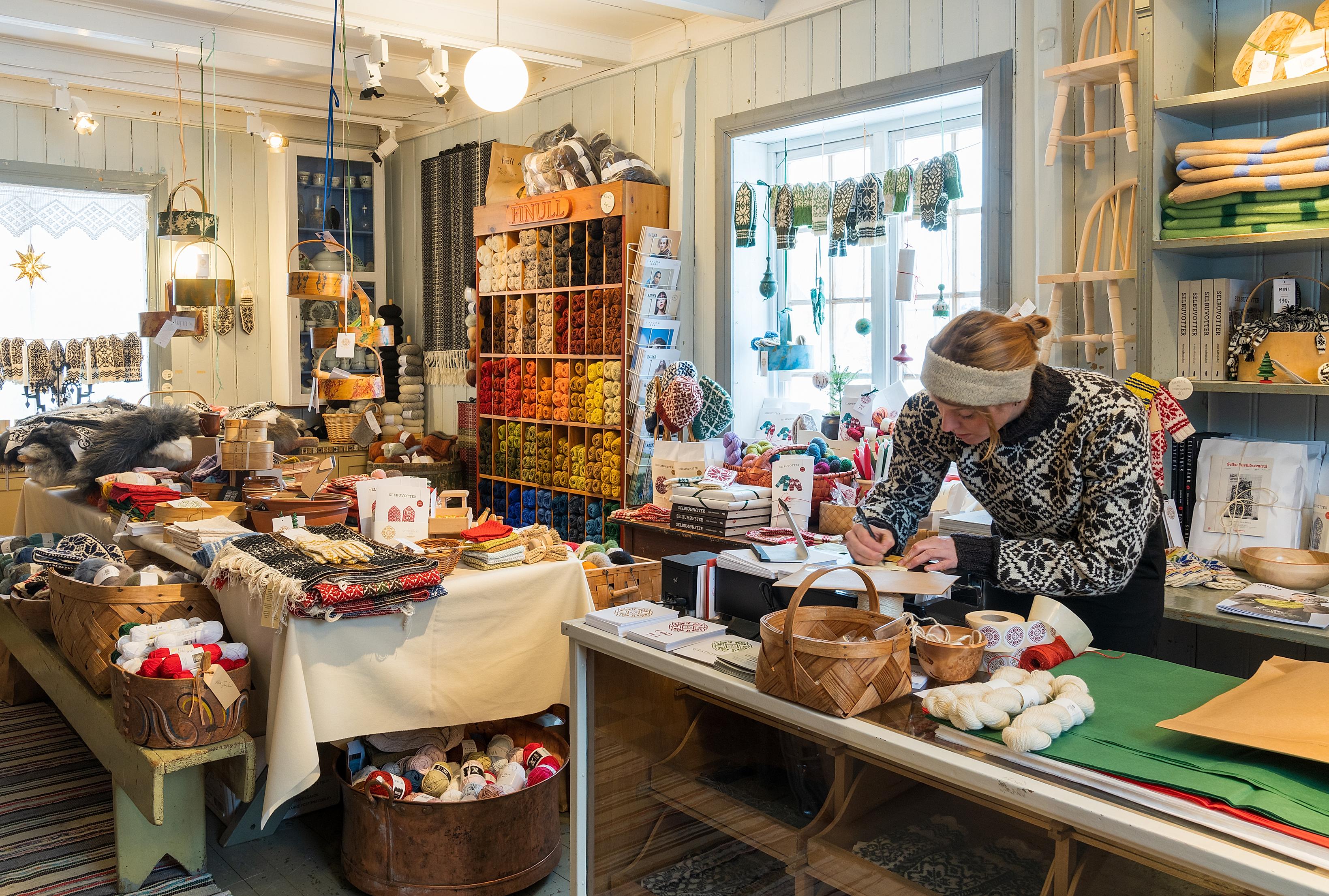 A woman working in the store at Selbu Husflidscentral, Trøndelag, Norway.