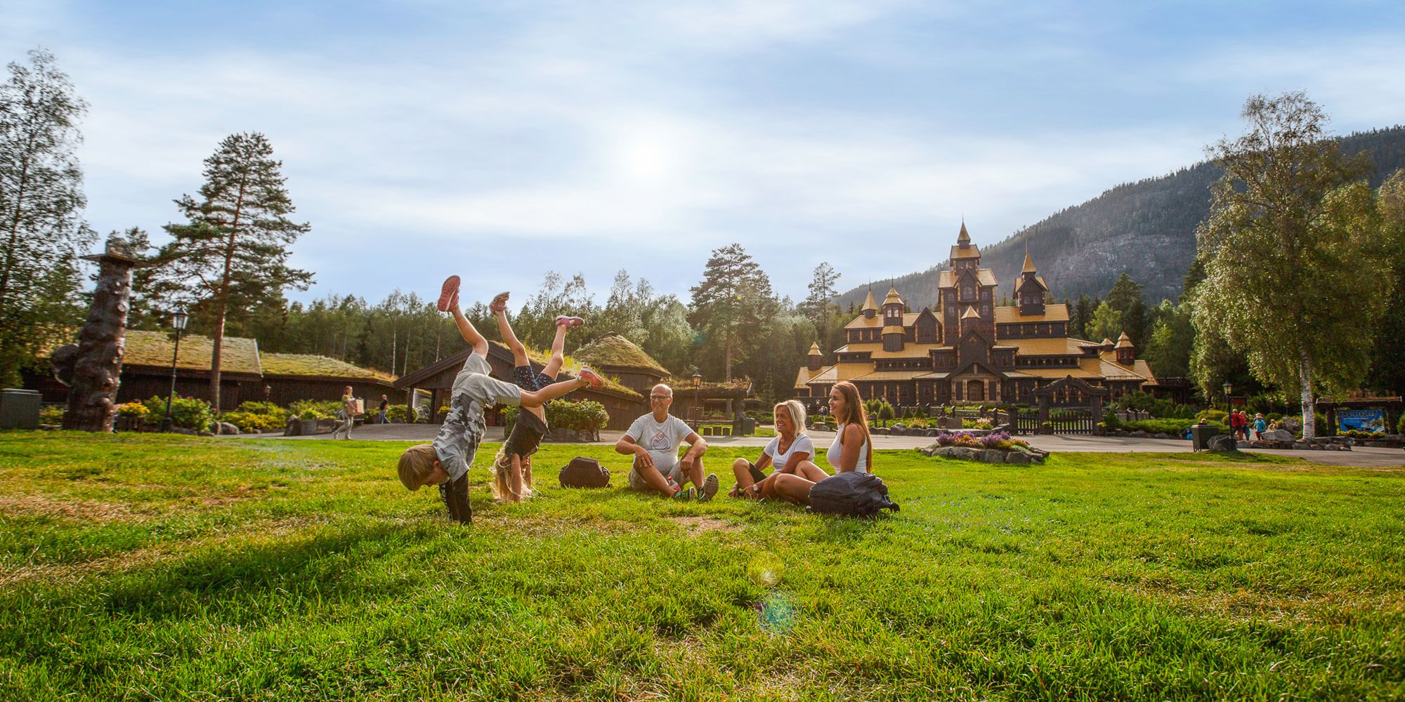 A family is having fun in front of the Fairy Tale Castle in Hunderfossen Adventure Park in Lillehammer, Eastern Norway