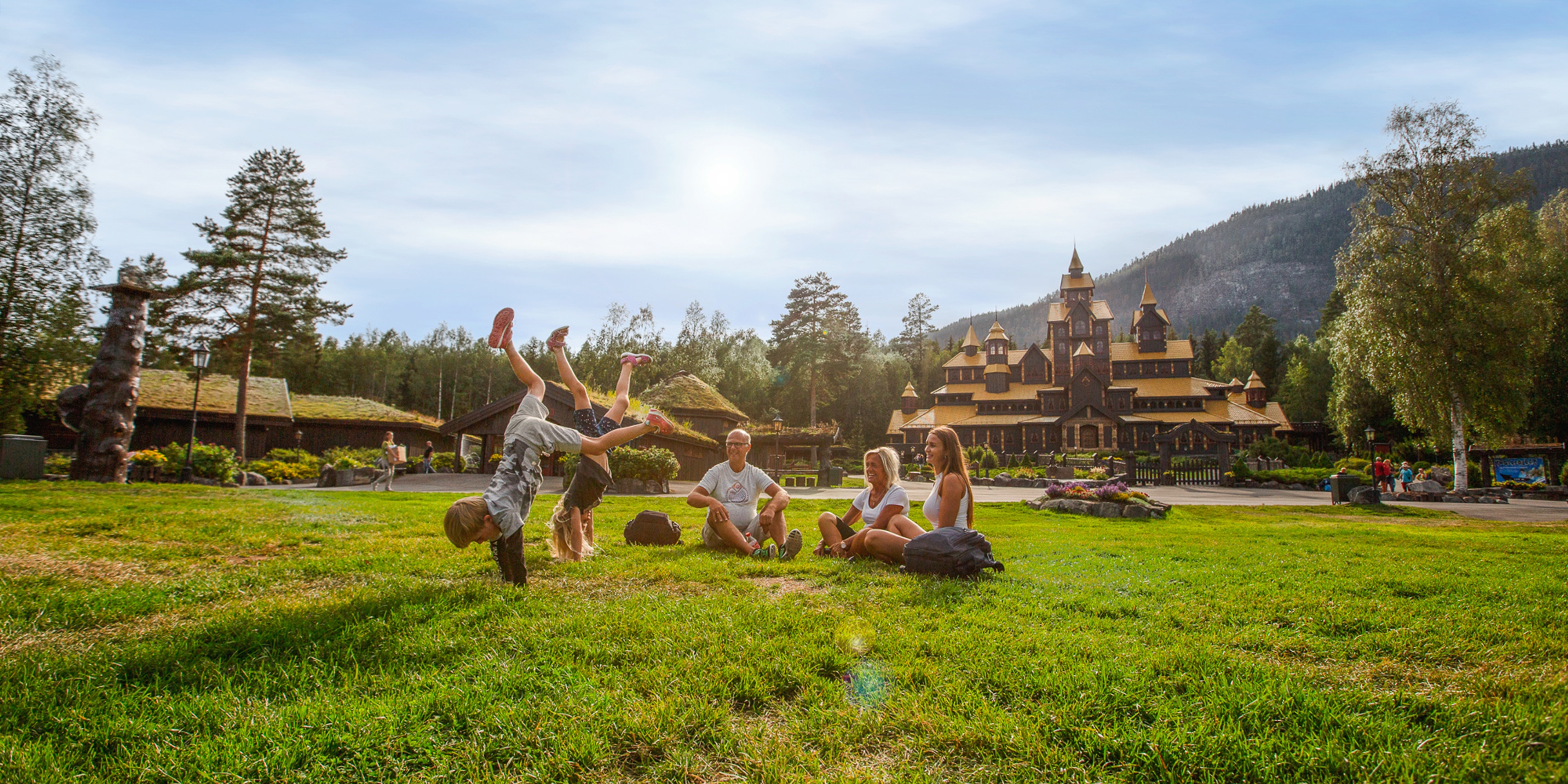 A family is having fun in front of the Fairy Tale Castle in Hunderfossen Adventure Park in Lillehammer, Eastern Norway