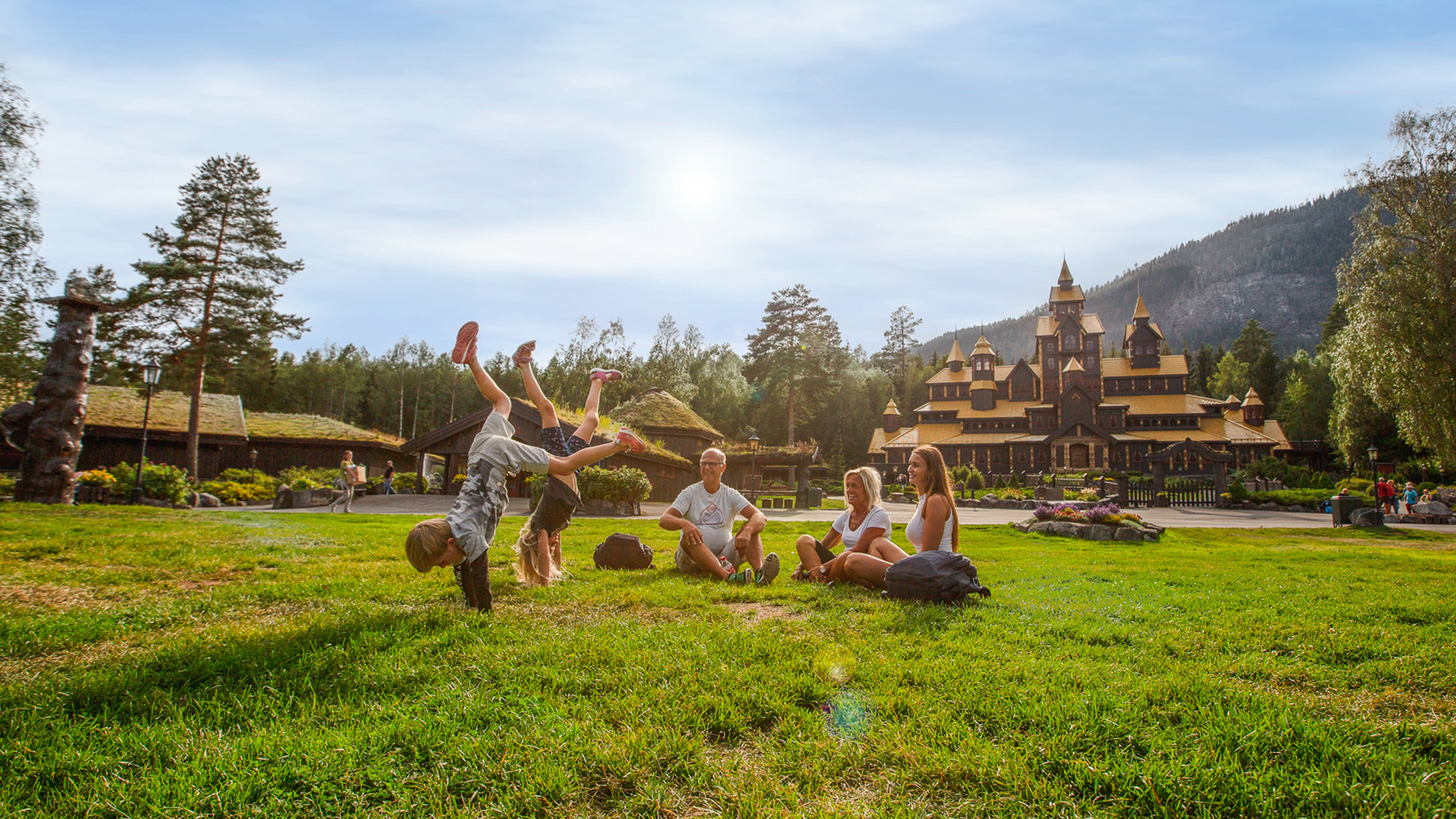 A family is having fun in front of the Fairy Tale Castle in Hunderfossen Adventure Park in Lillehammer, Eastern Norway