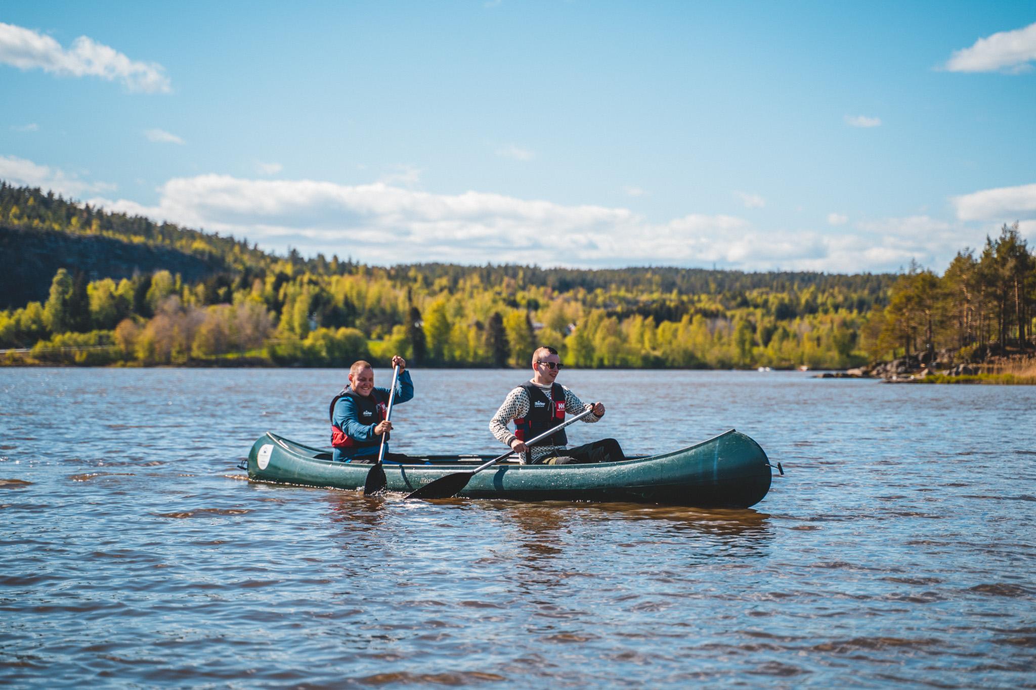 Two persons in a canoe on the Halden canal in summer, Eastern Norway.