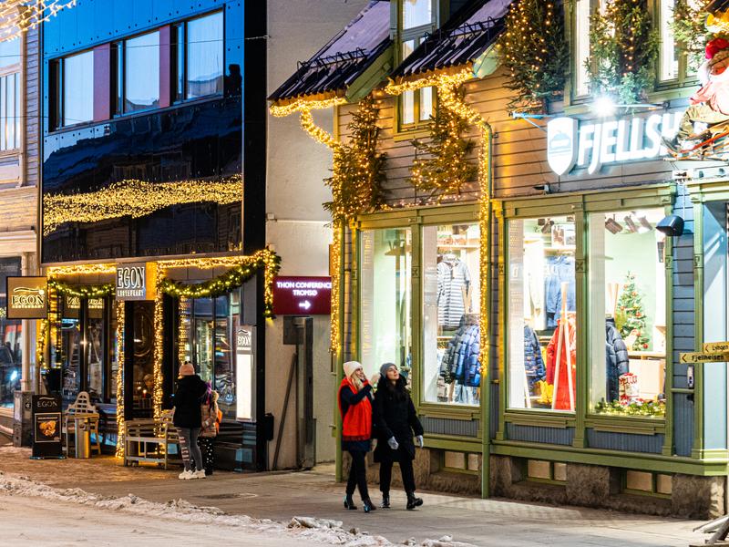 Two girls strolling in the Christmas decorated streets in Tromsø