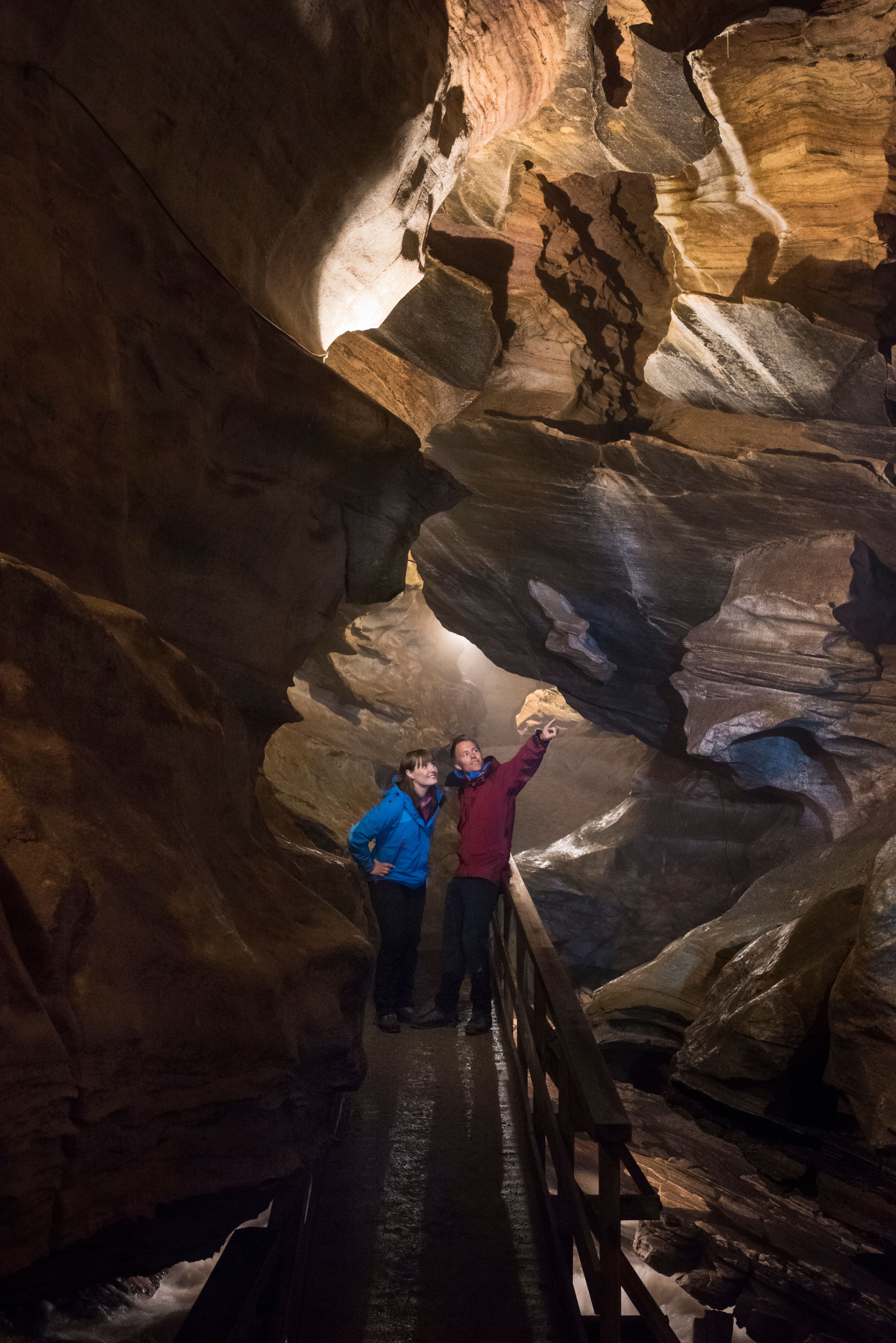 Two people inside the Grønligrotta cave in Helgeland in Northern Norway