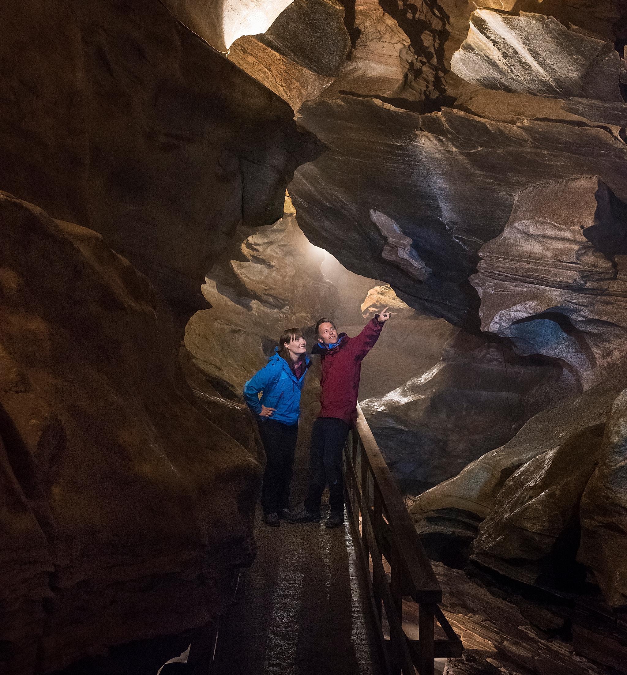 Two people inside the Grønligrotta cave in Helgeland in Northern Norway