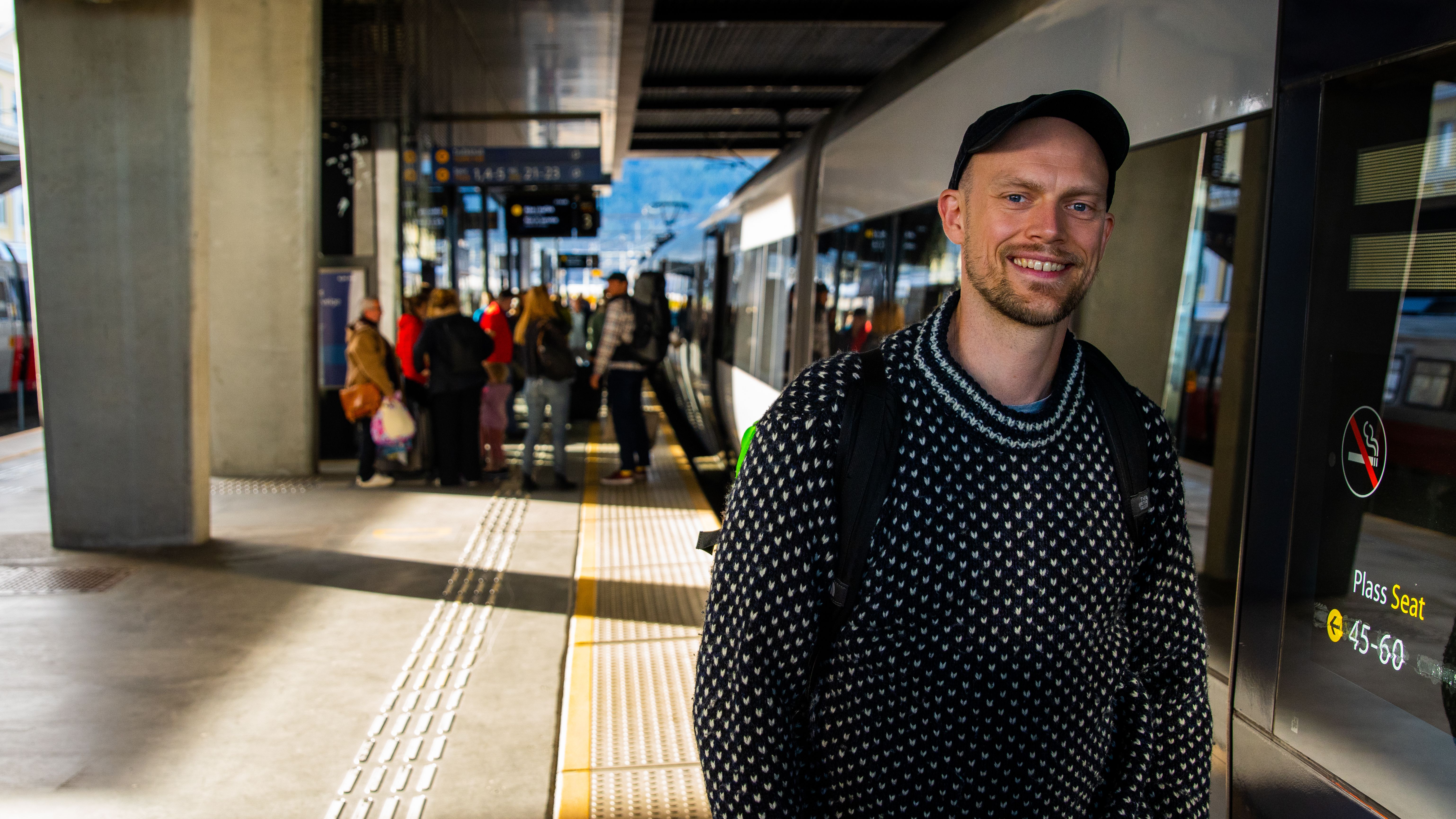 A man standing at a train station