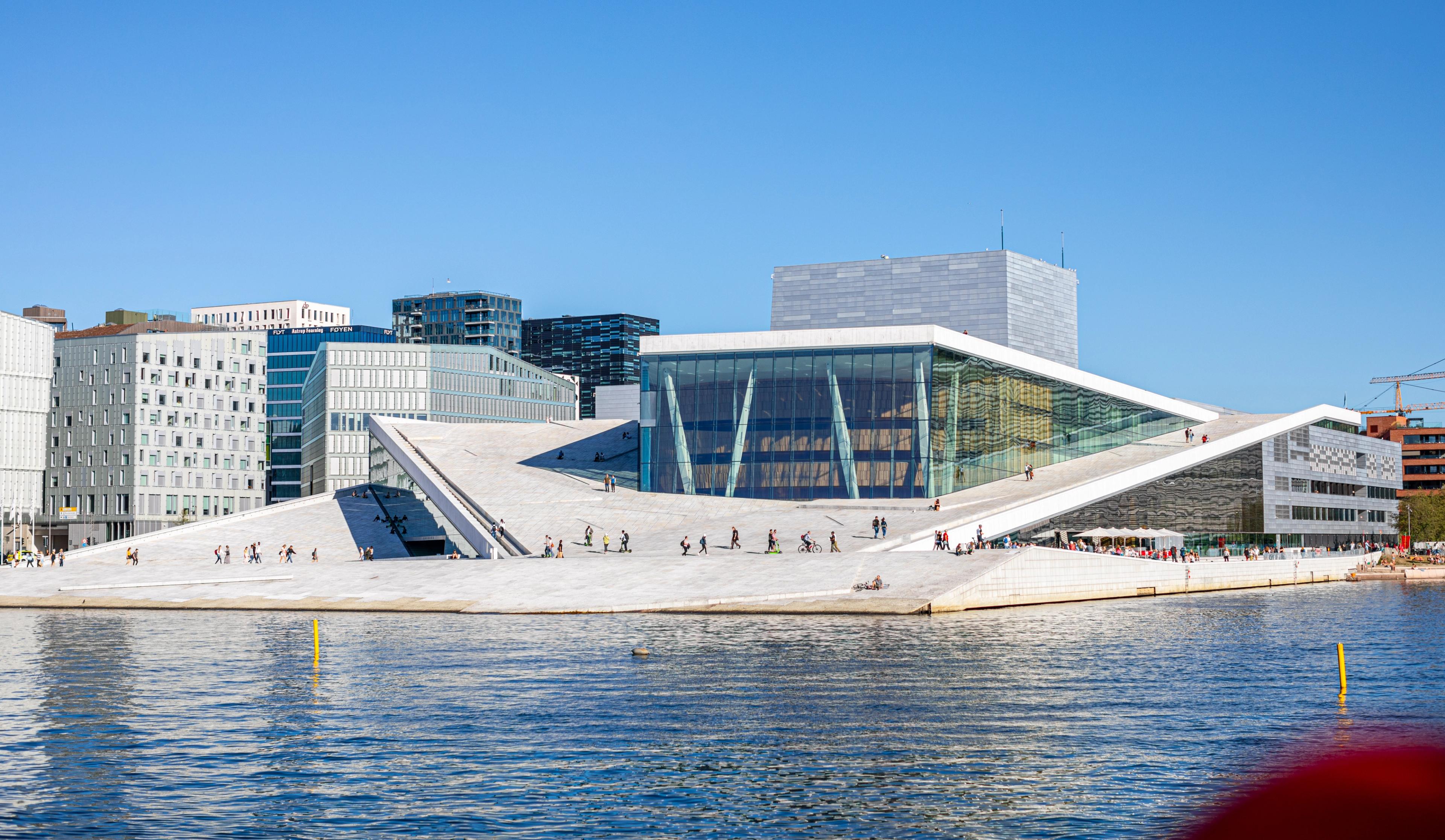 People walking across the roof of The Oslo Opera House