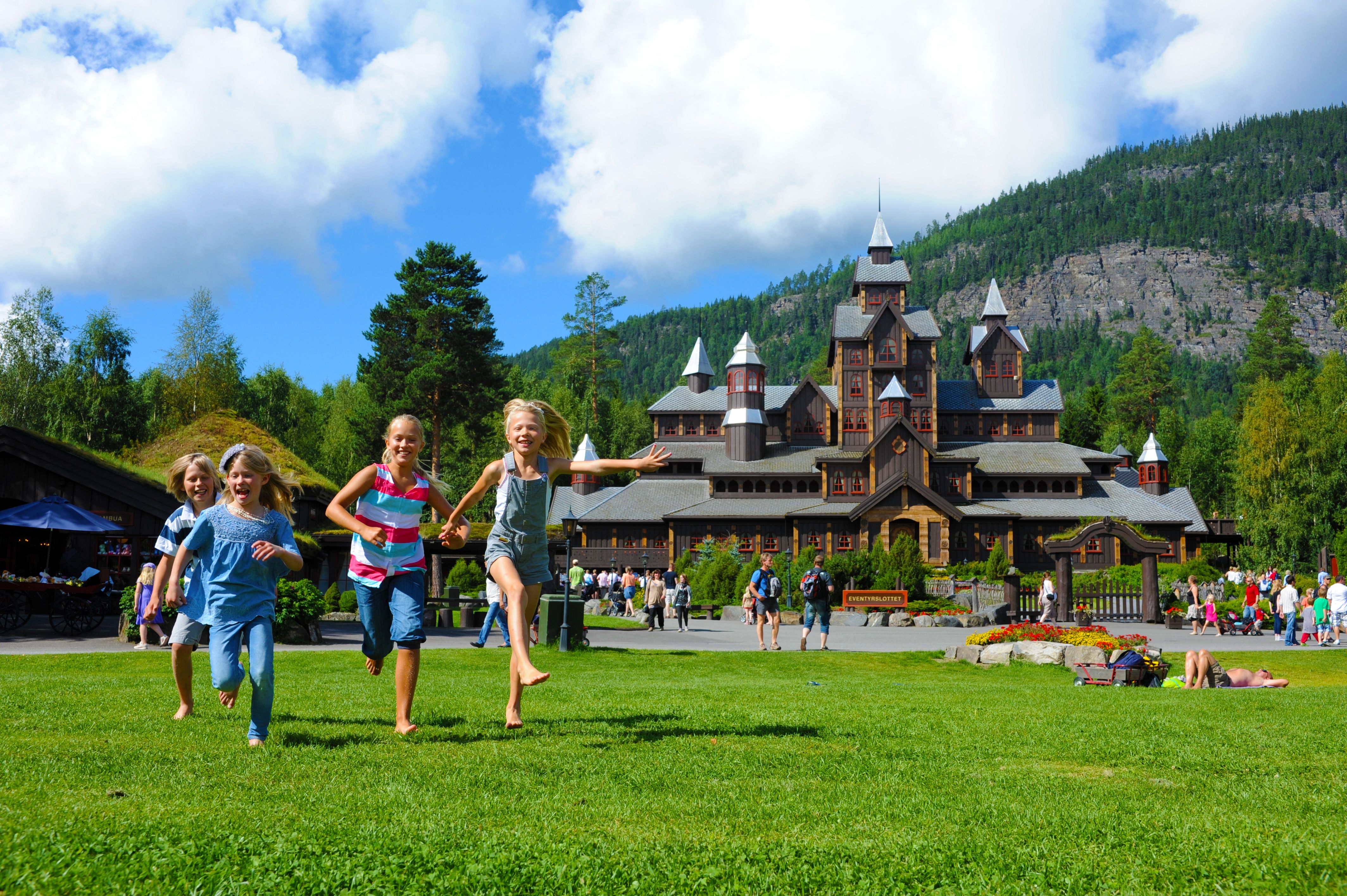 Children running in front of the Fairy tale castle in Hunderfossen family park in the Lillehammer region, Eastern Norway