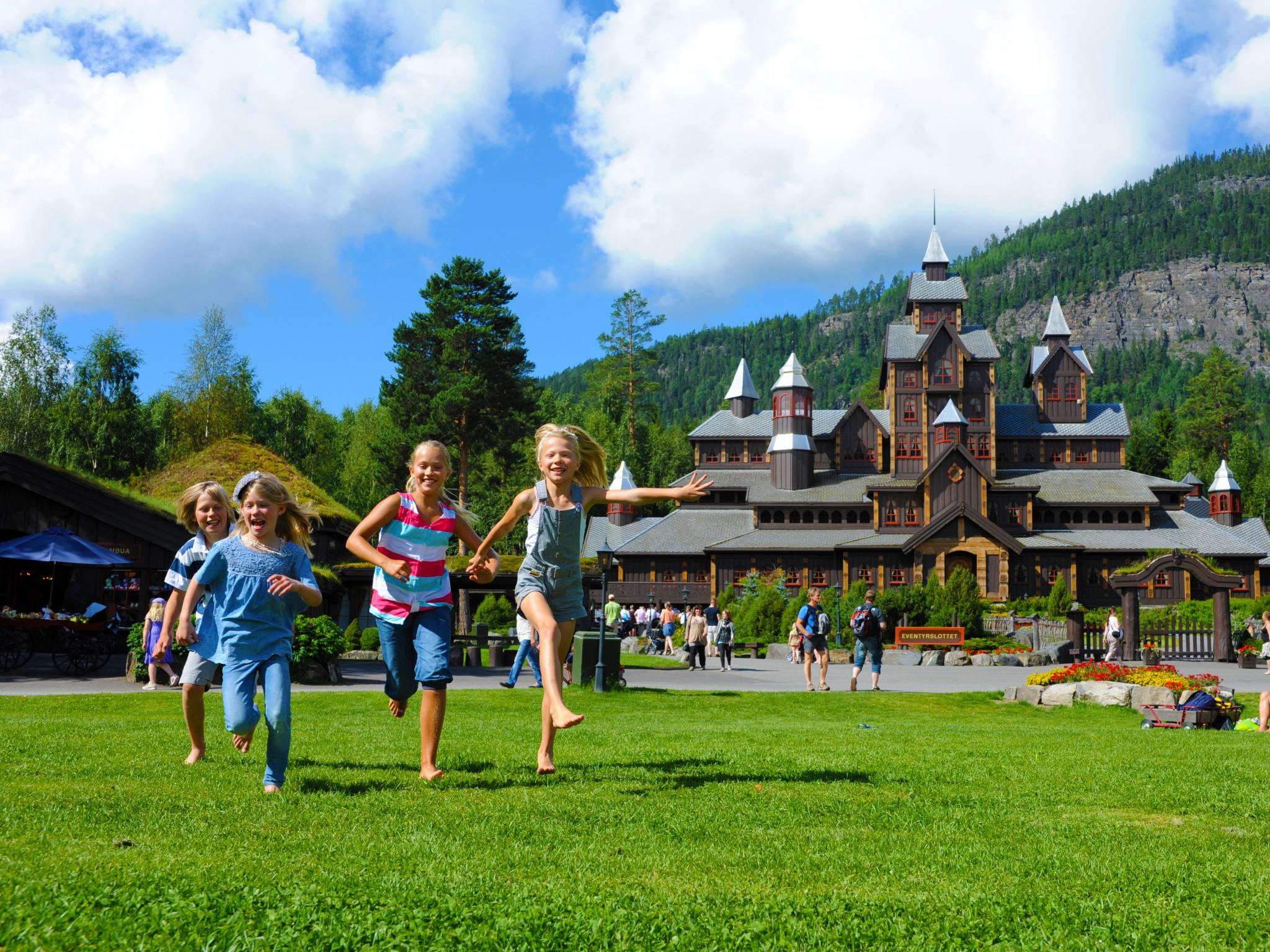 Children running in front of the Fairy tale castle in Hunderfossen family park in the Lillehammer region, Eastern Norway