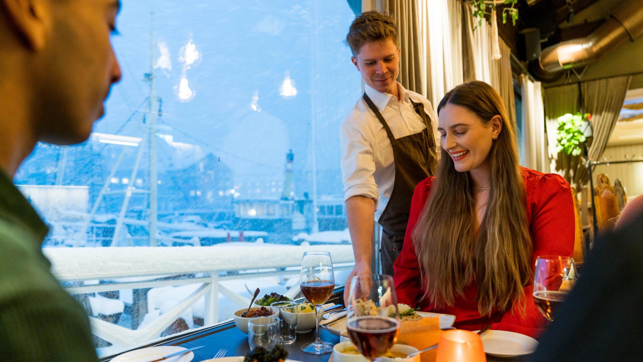Several people enjoying a dinner at Troll restaurant in Trondheim, Trøndelag, Norway.