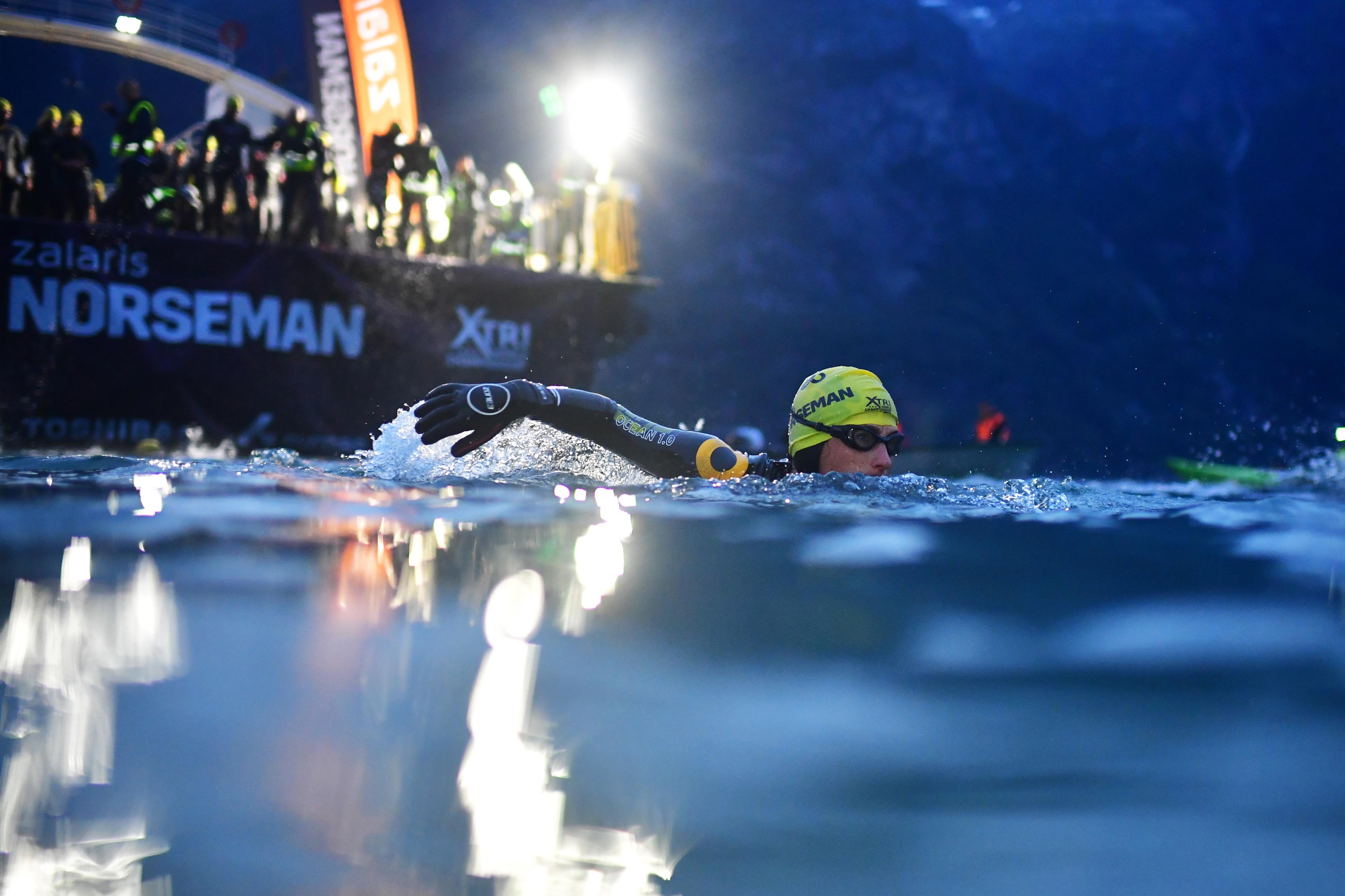 A man swimming in Hardangerfjorden during a Norseman triathlon