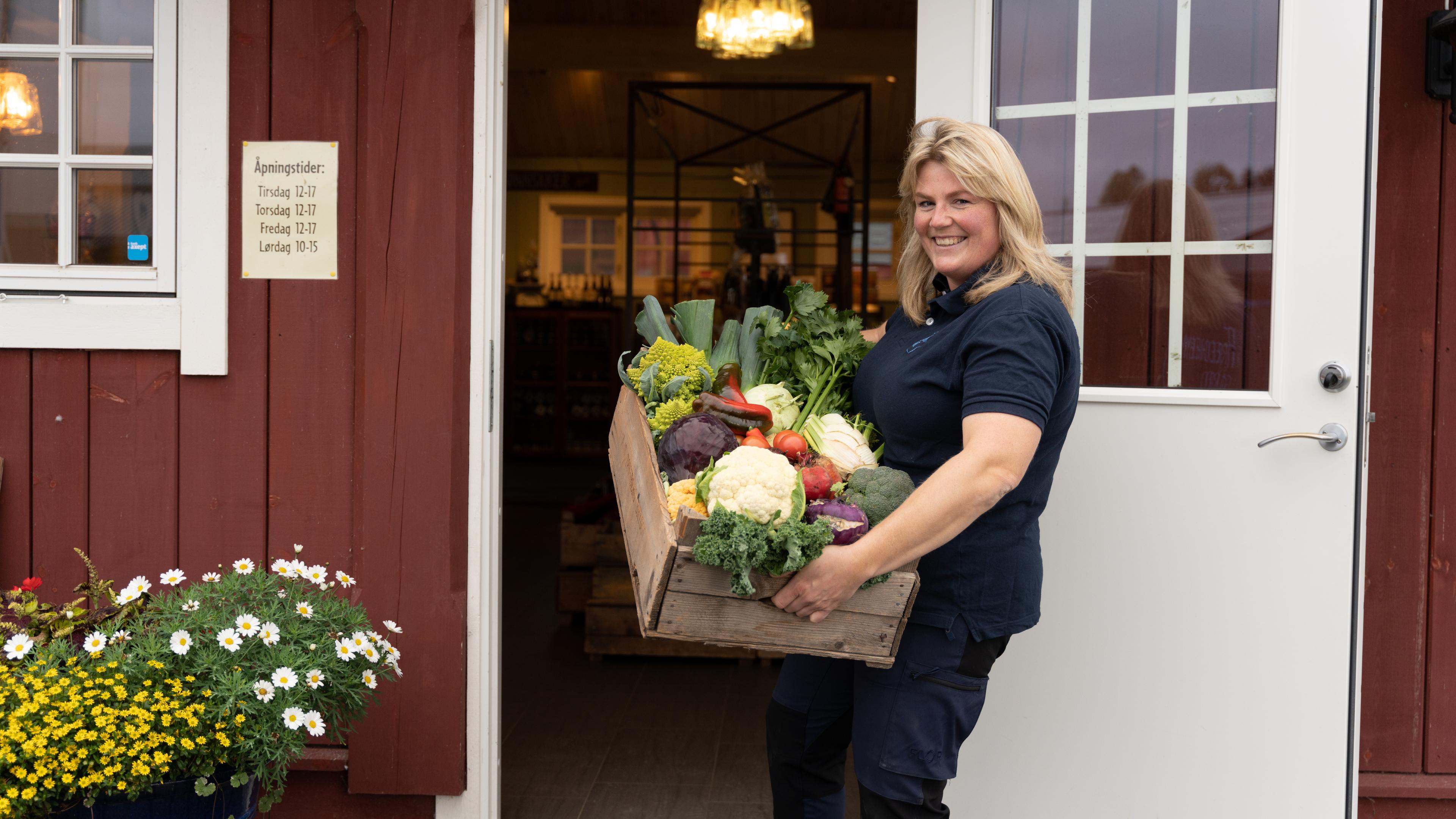 A woman welcomes you to Fredheim farm shop at Stange, Eastern Norway.
