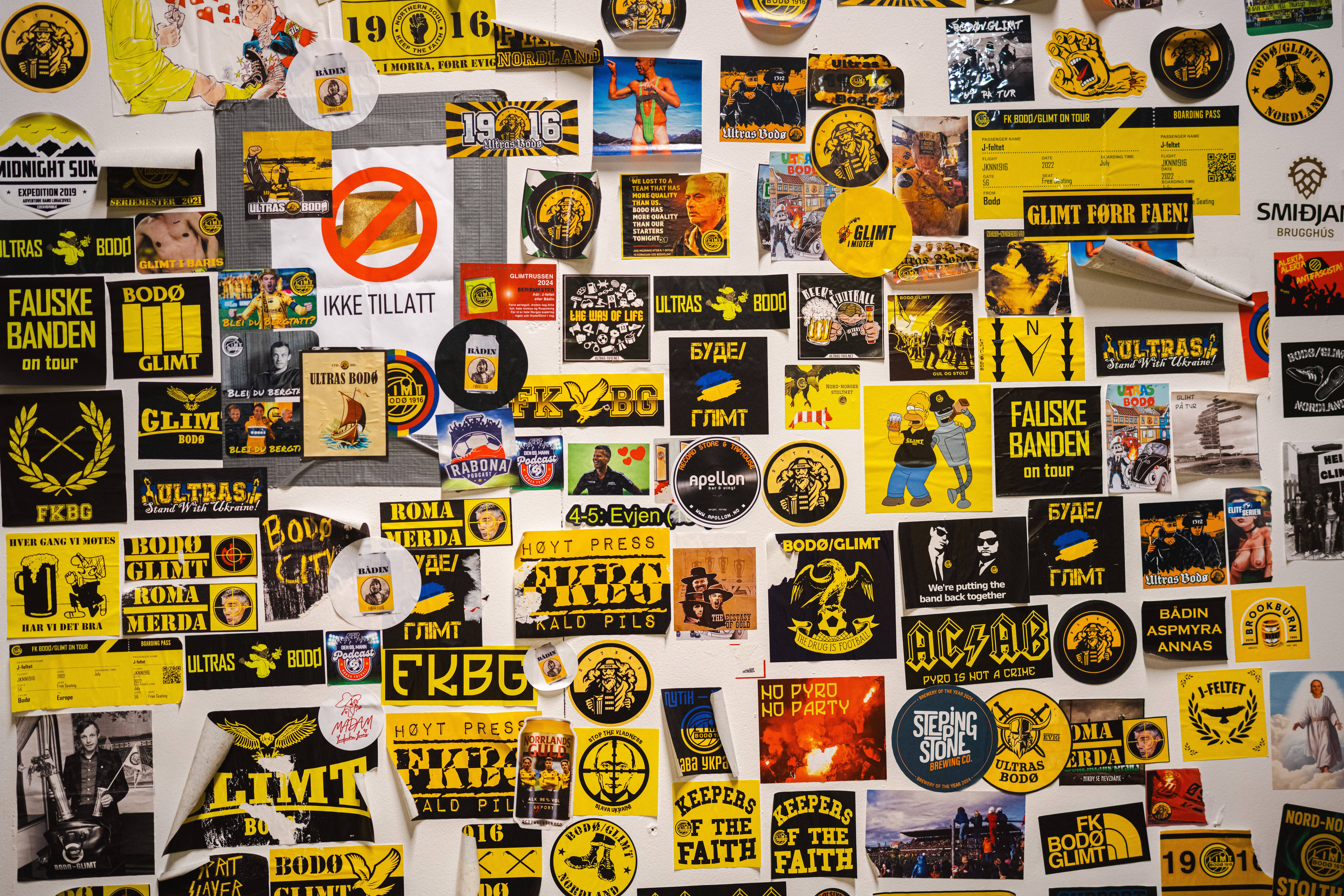 Bodø/Glimt stickers on a wall.