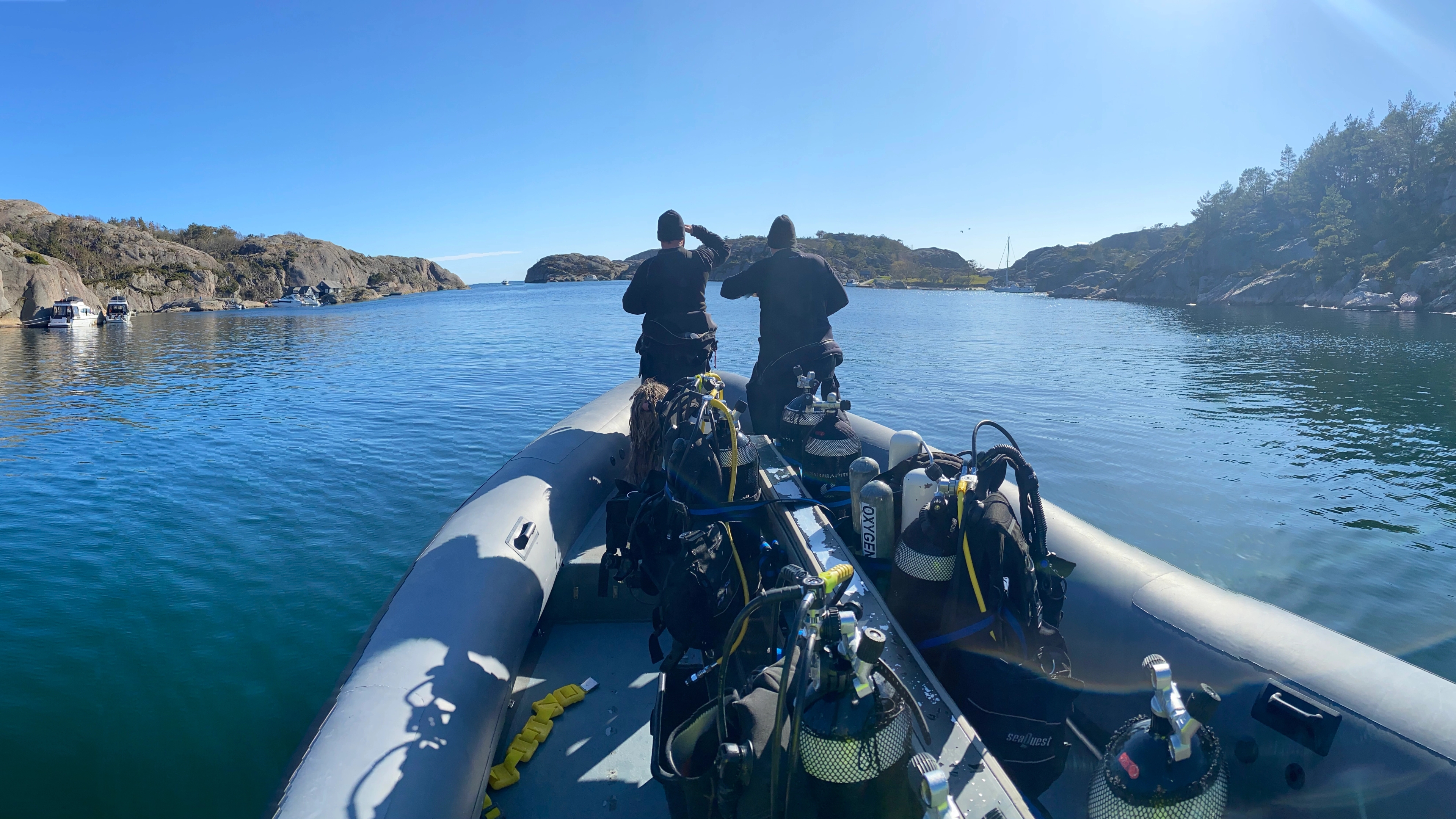 Two people in a boat, ready to scuba dive in Southern Norway