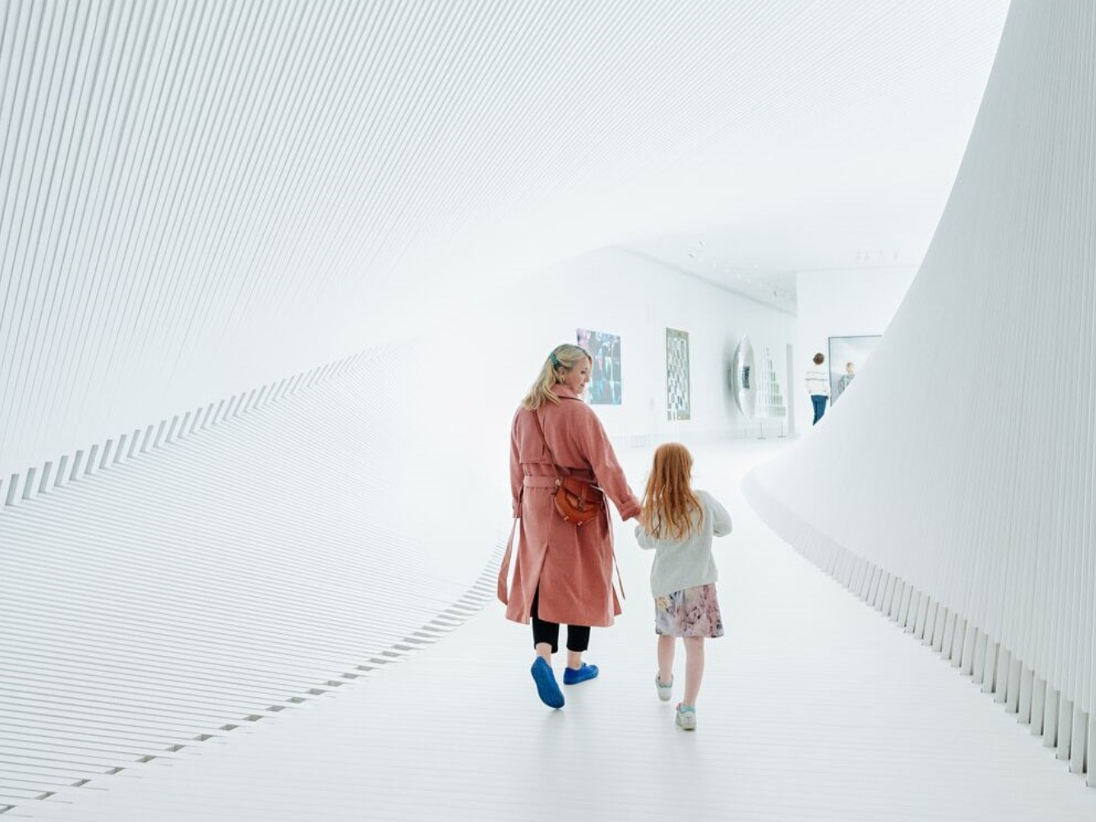 Mother and child walking inside The Twist at Kistefos, Hadeland