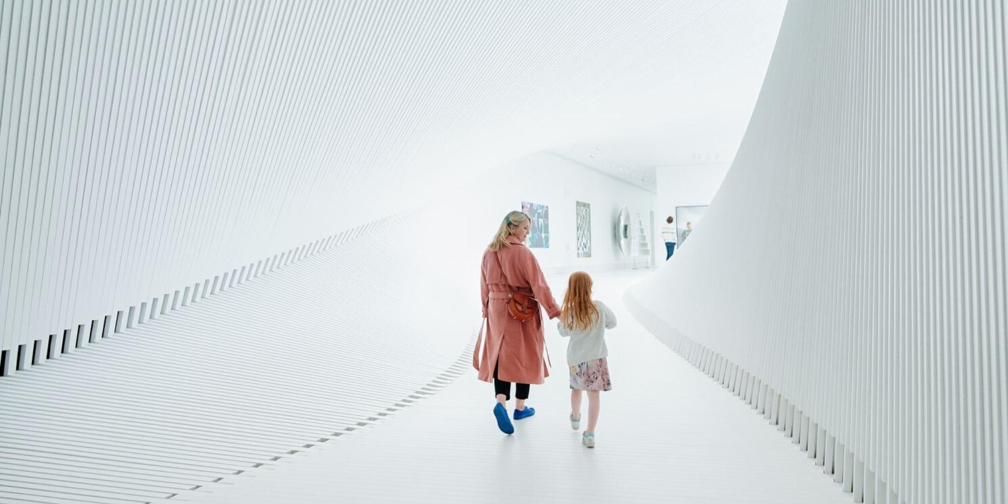 Mother and child walking inside The Twist at Kistefos, Hadeland