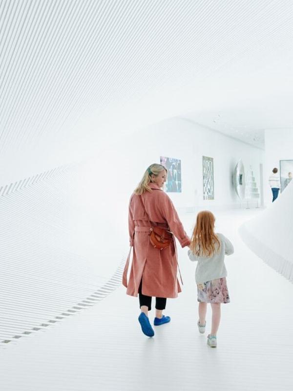 Mother and child walking inside The Twist at Kistefos, Hadeland