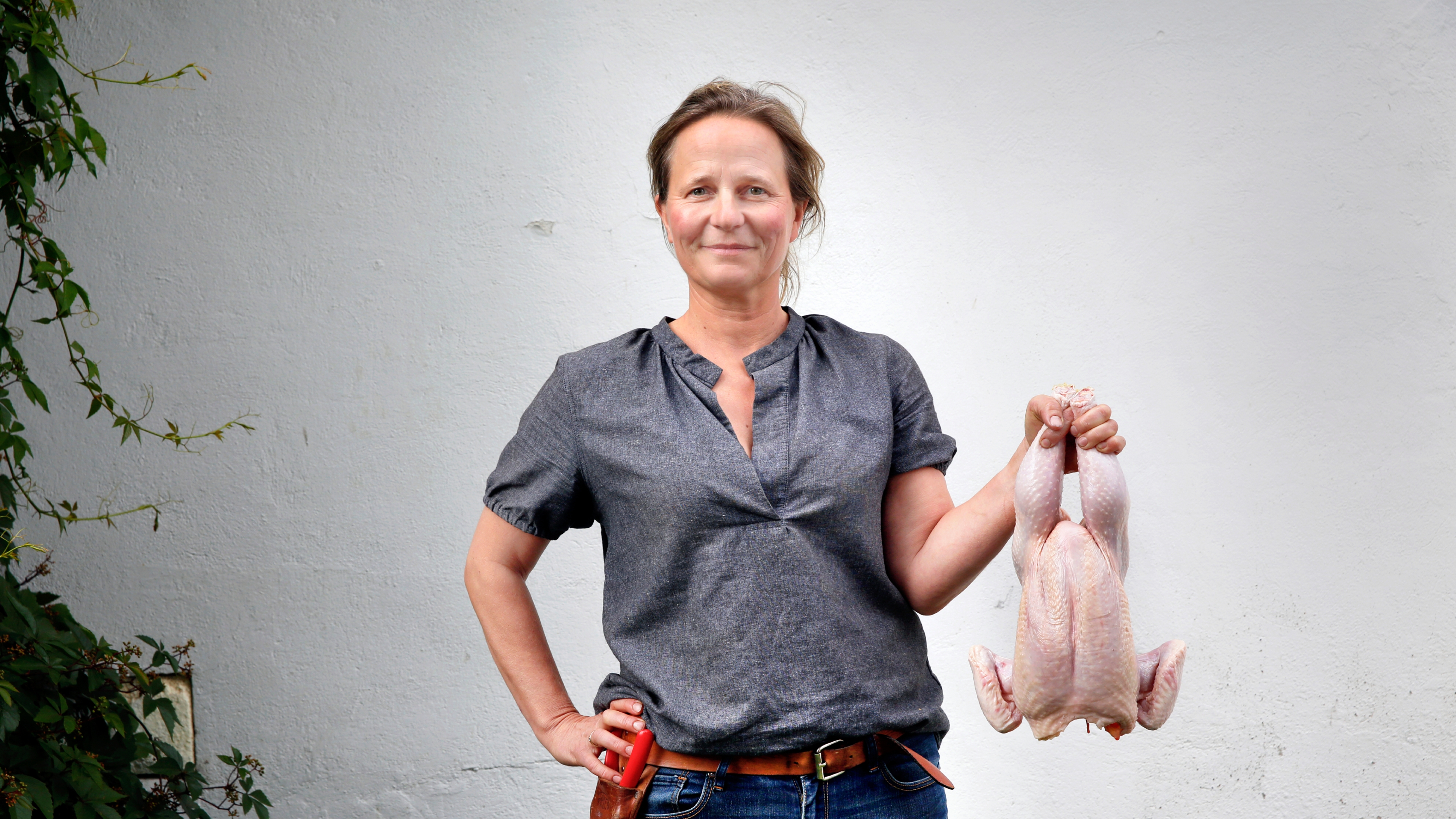 Marianne hold a chicken at the Hovelsrud farm by lake Mjøsa, Eastern Norway.