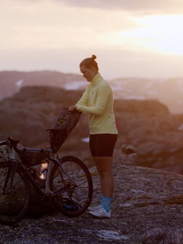 Girl with bike on top of mountain