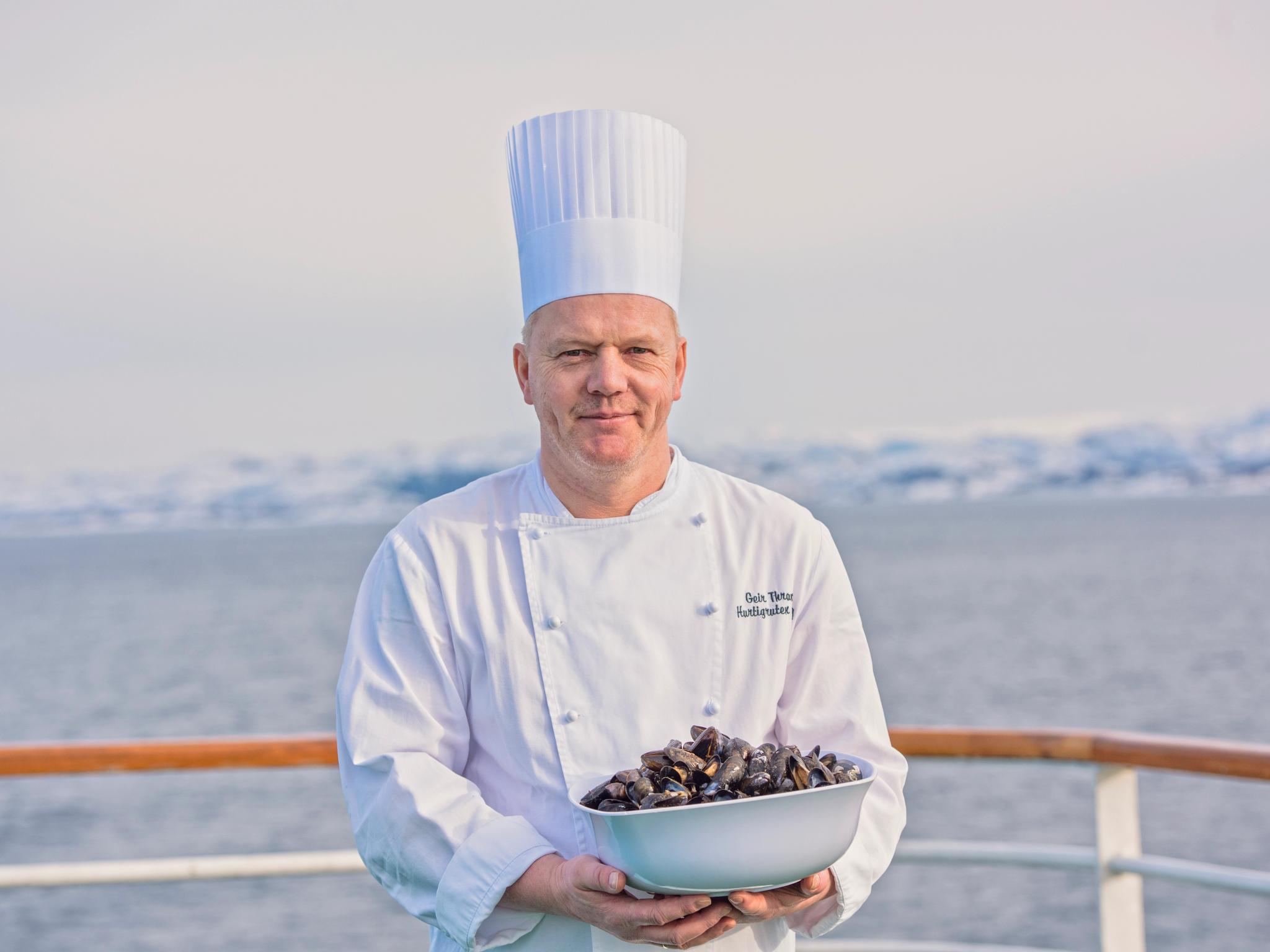 Chef holding mussels on Hurtigruten's deck
