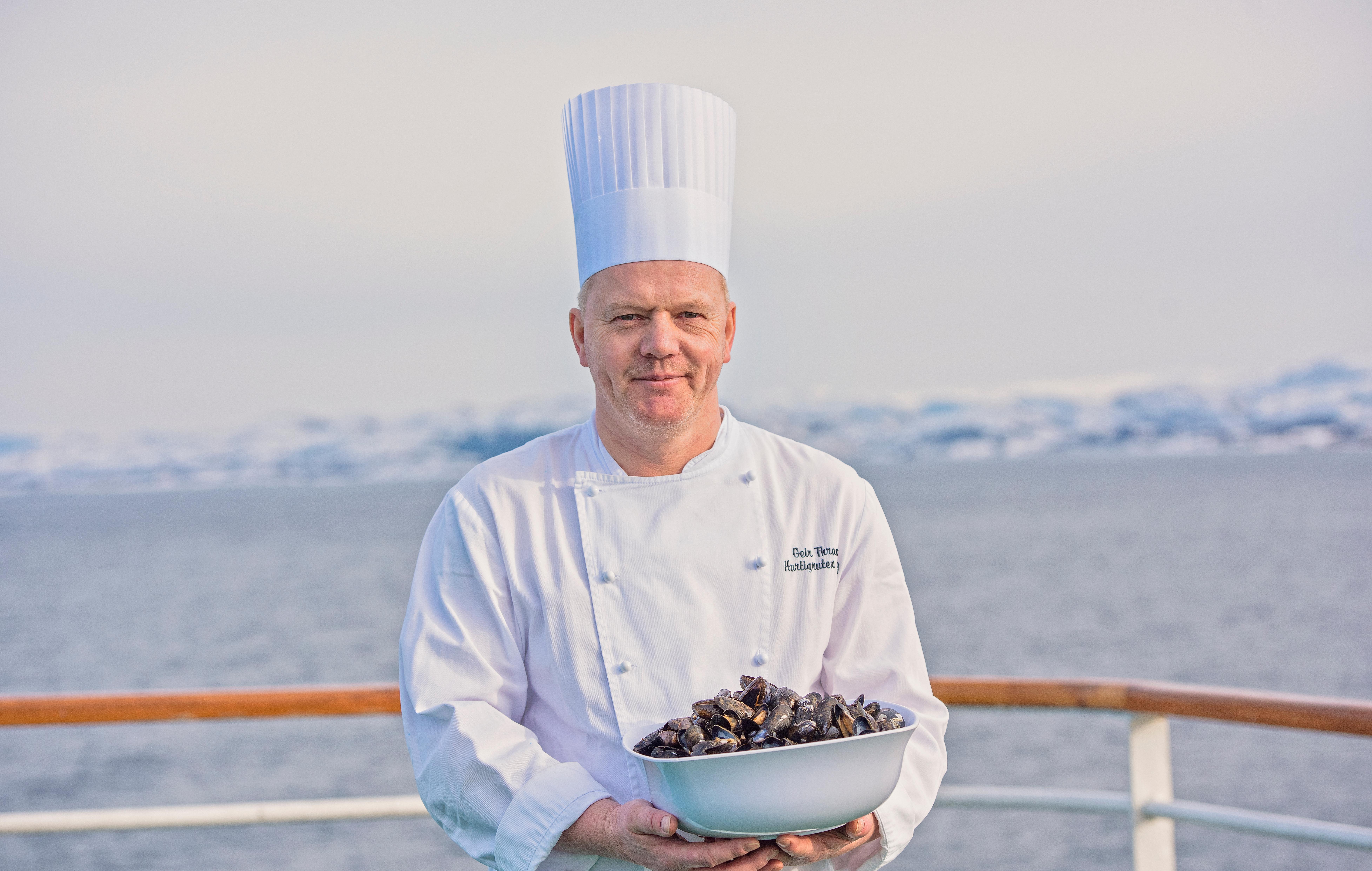 Chef holding mussels on Hurtigruten's deck