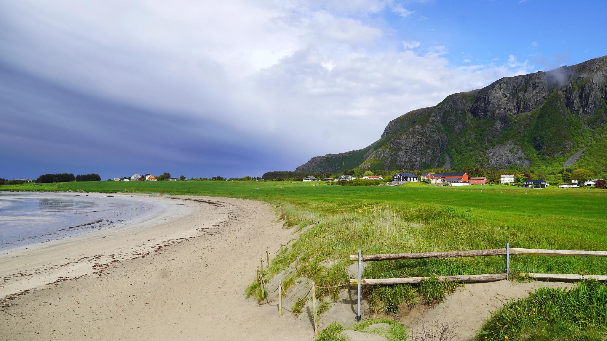 Farstadsanden golden beach and mountains behind.