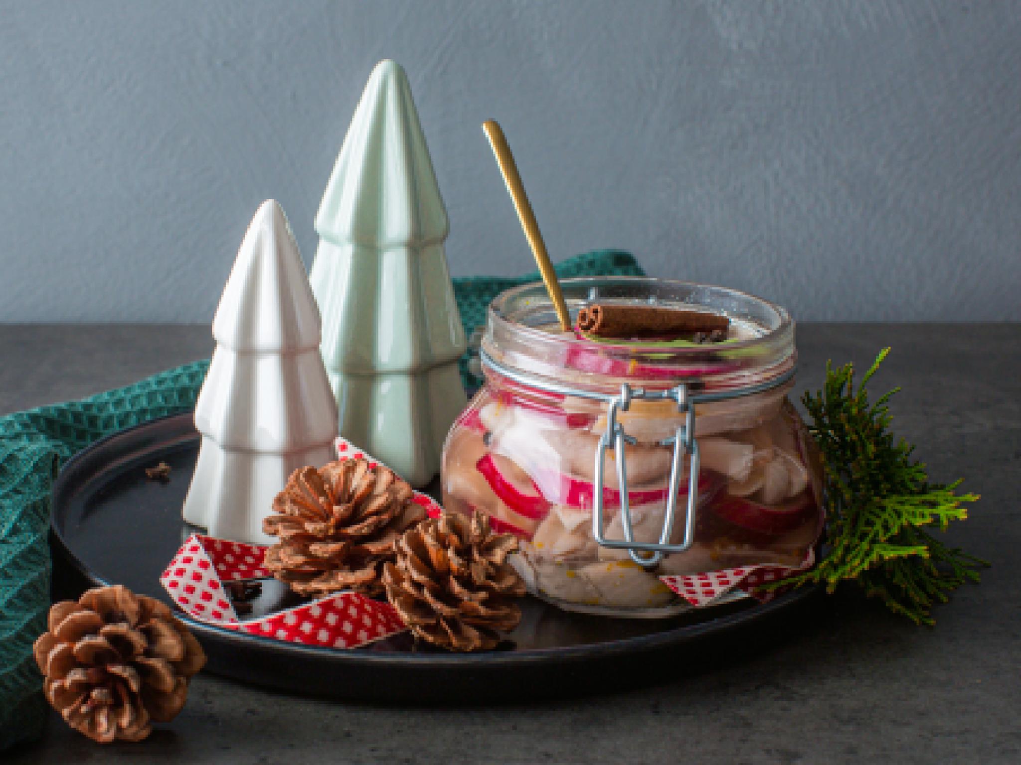 Traditional Norwegian pickled herring in a glass jar.