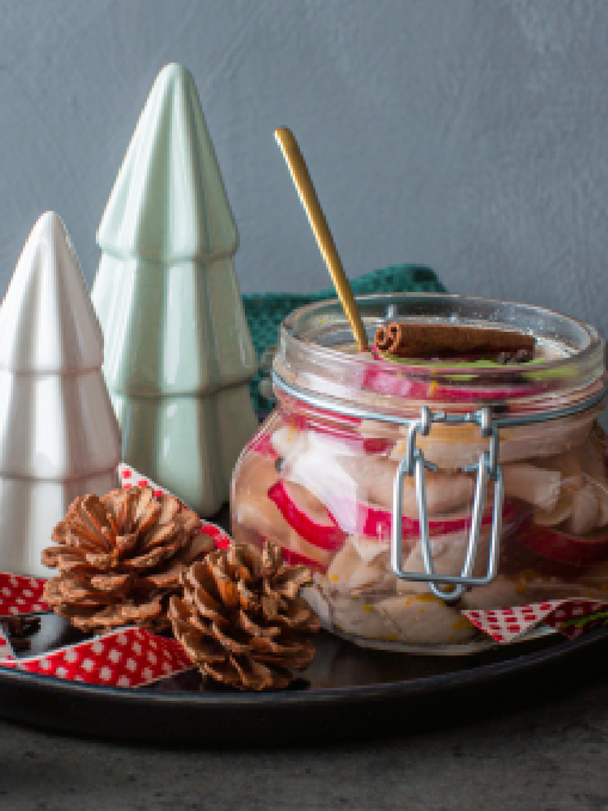 Traditional Norwegian pickled herring in a glass jar.