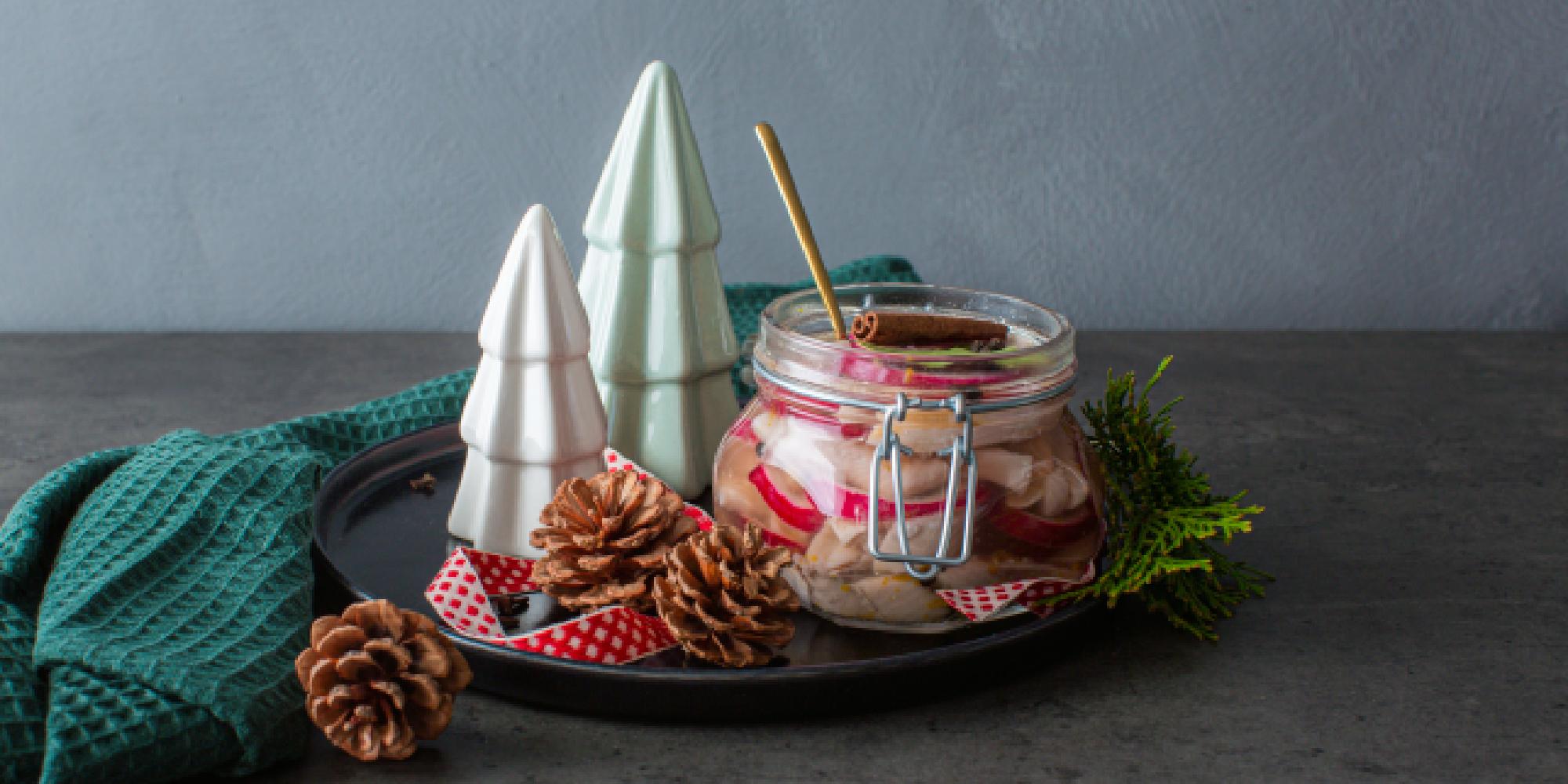 Traditional Norwegian pickled herring in a glass jar.