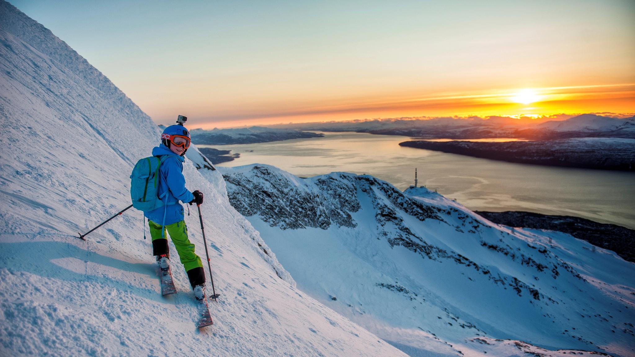 A boy is ski touring during sunset in Narvikfjellet in Northern Norway