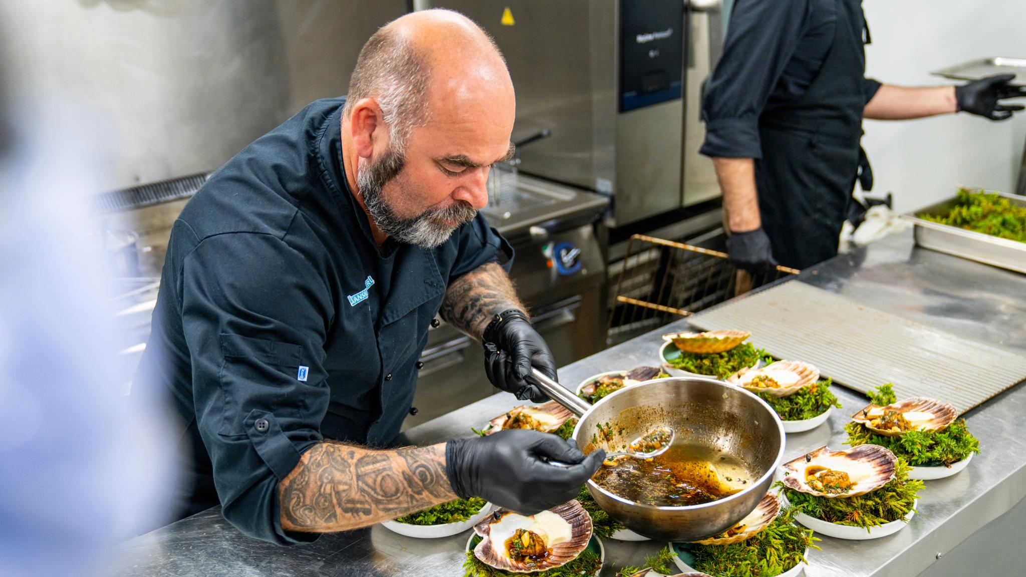The Head Chef at Ansnes Brygger preparing scallops in the kithcen
