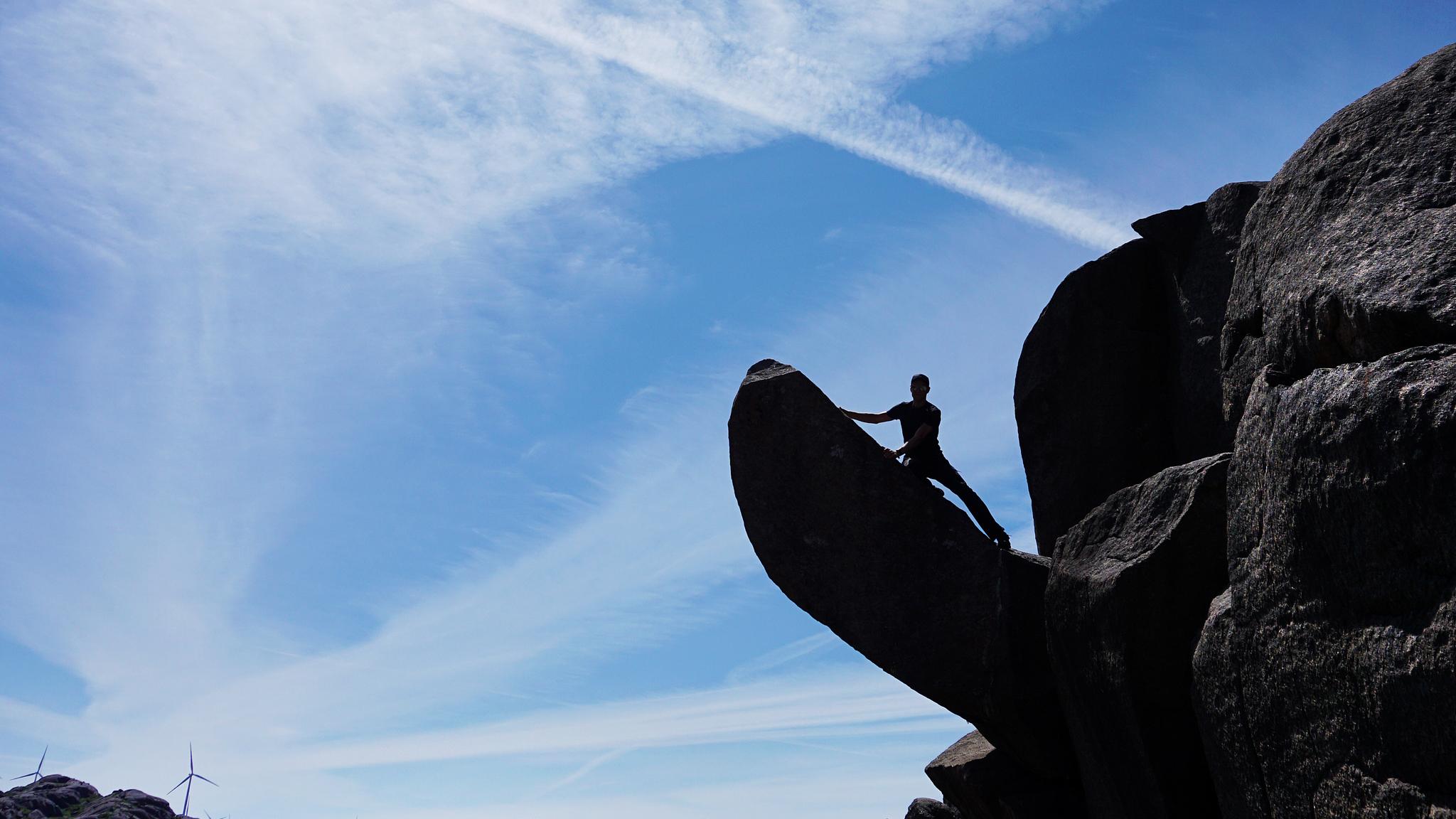 Man climbing the Trollpikken rock in Egersund