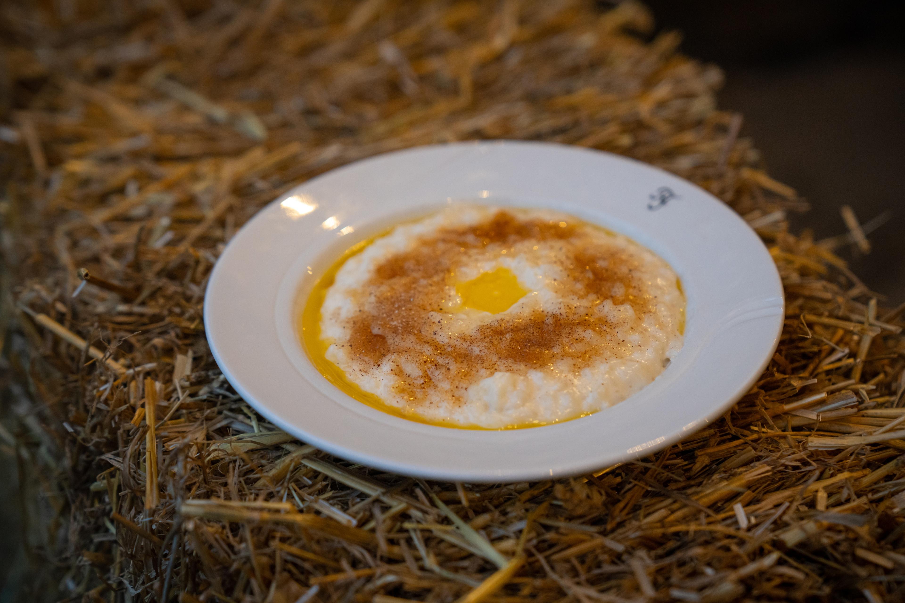 A bowl of traditional rice porridge topped with cinnamon and butter