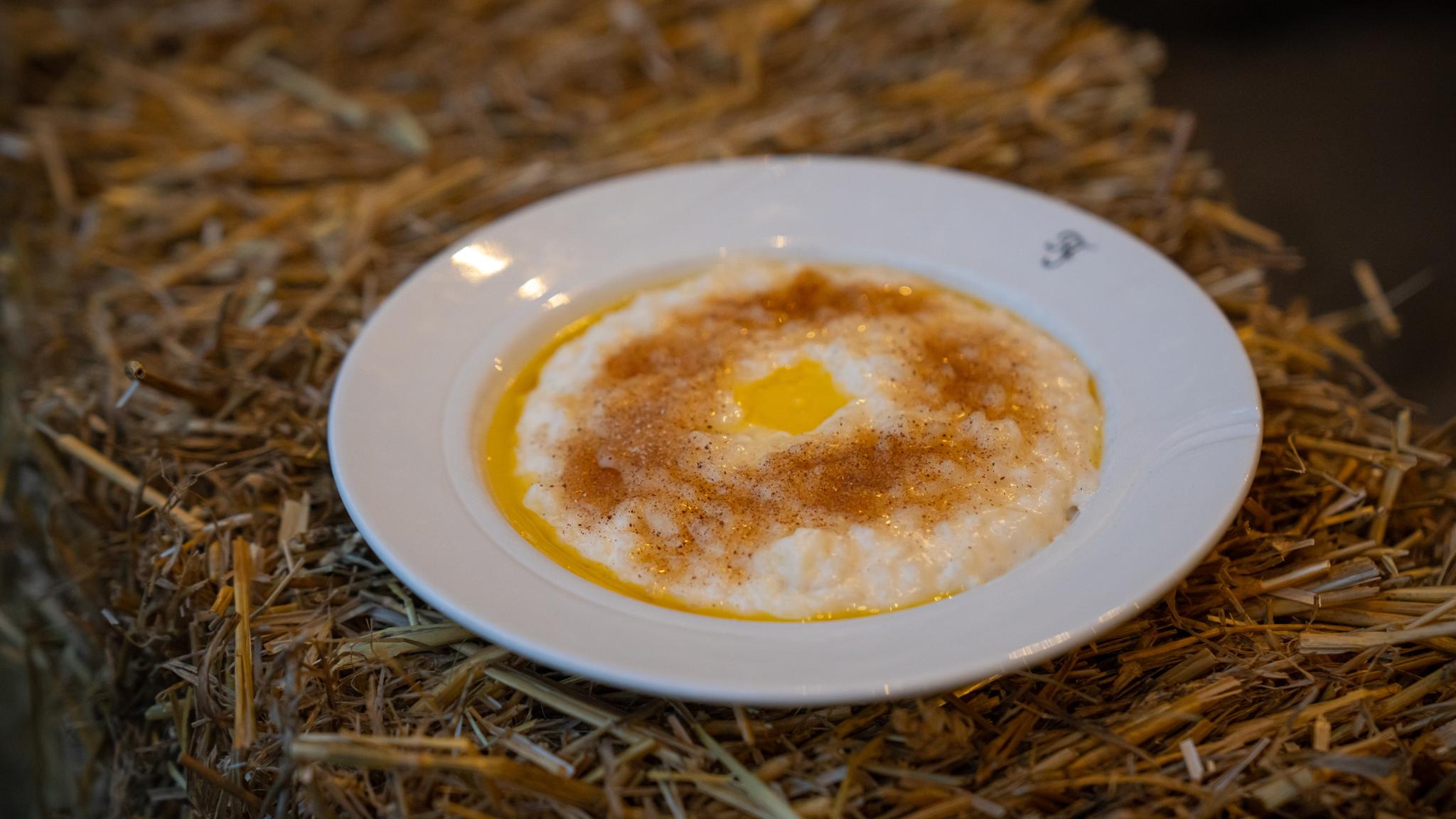 A bowl of traditional rice porridge topped with cinnamon and butter