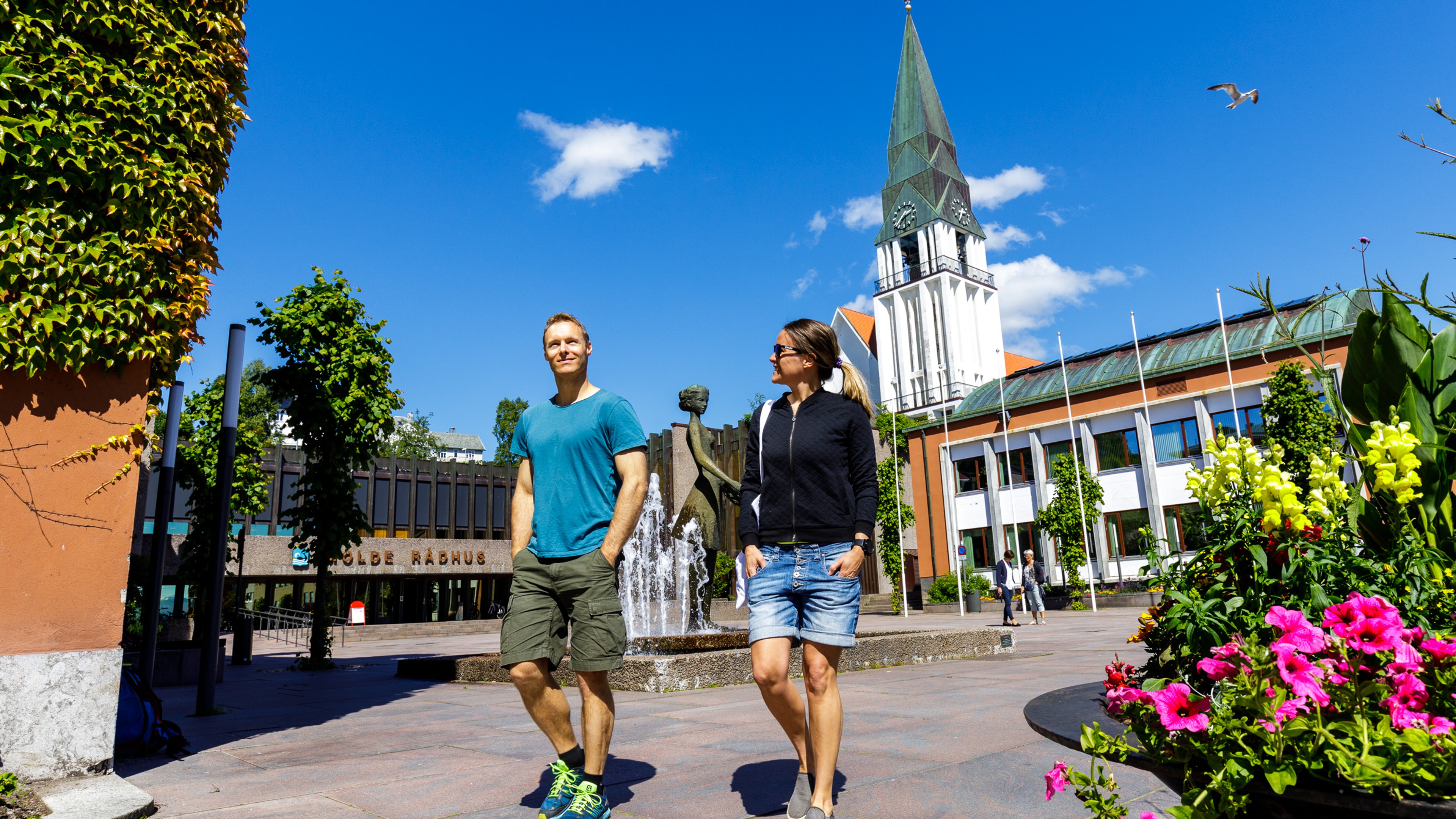 Two people in front of the the Molde Cathedral in Northwest, Fjord Norway.