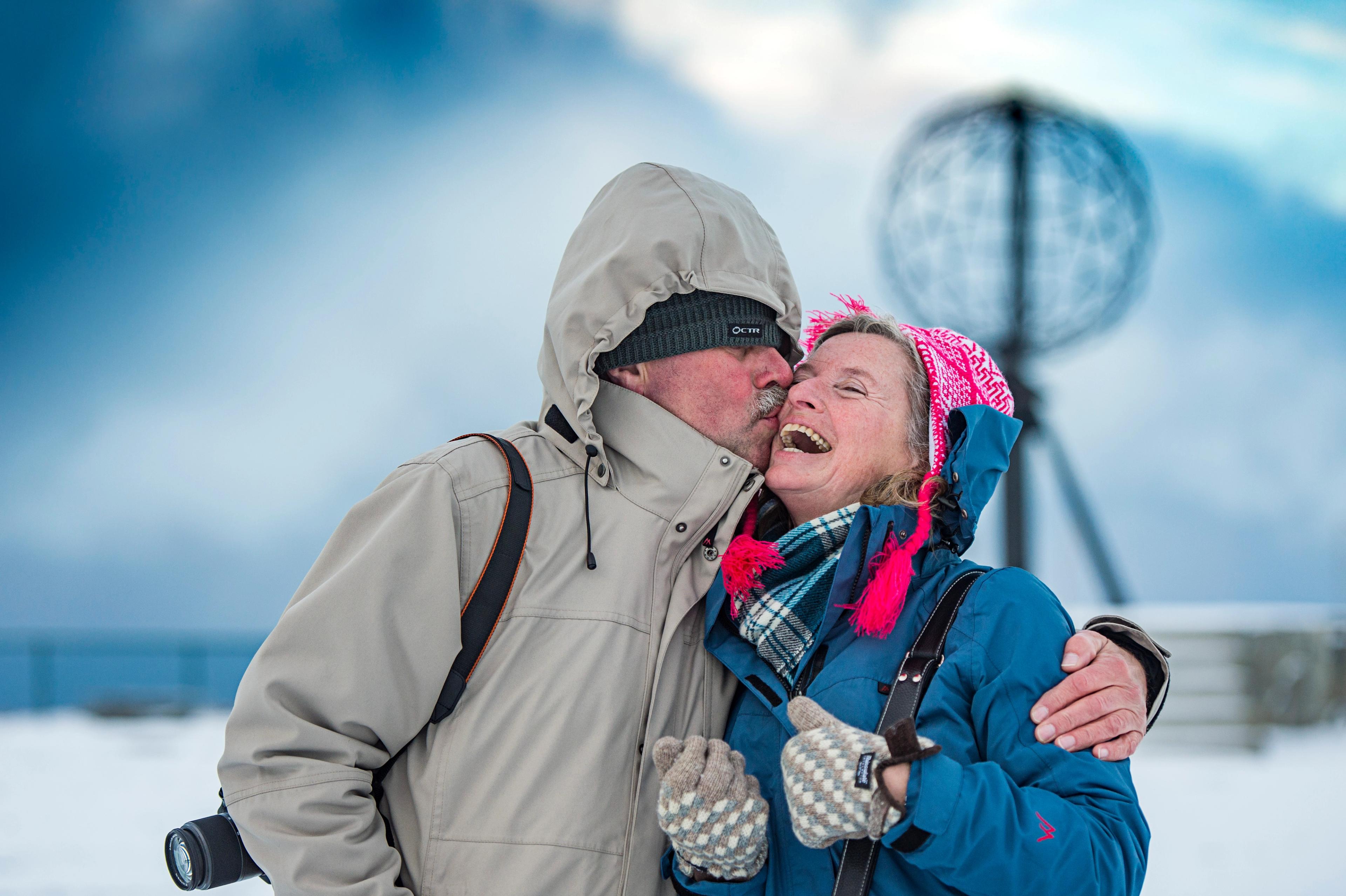 Couple kissing in front of the North Cape Globe, at Magerøya