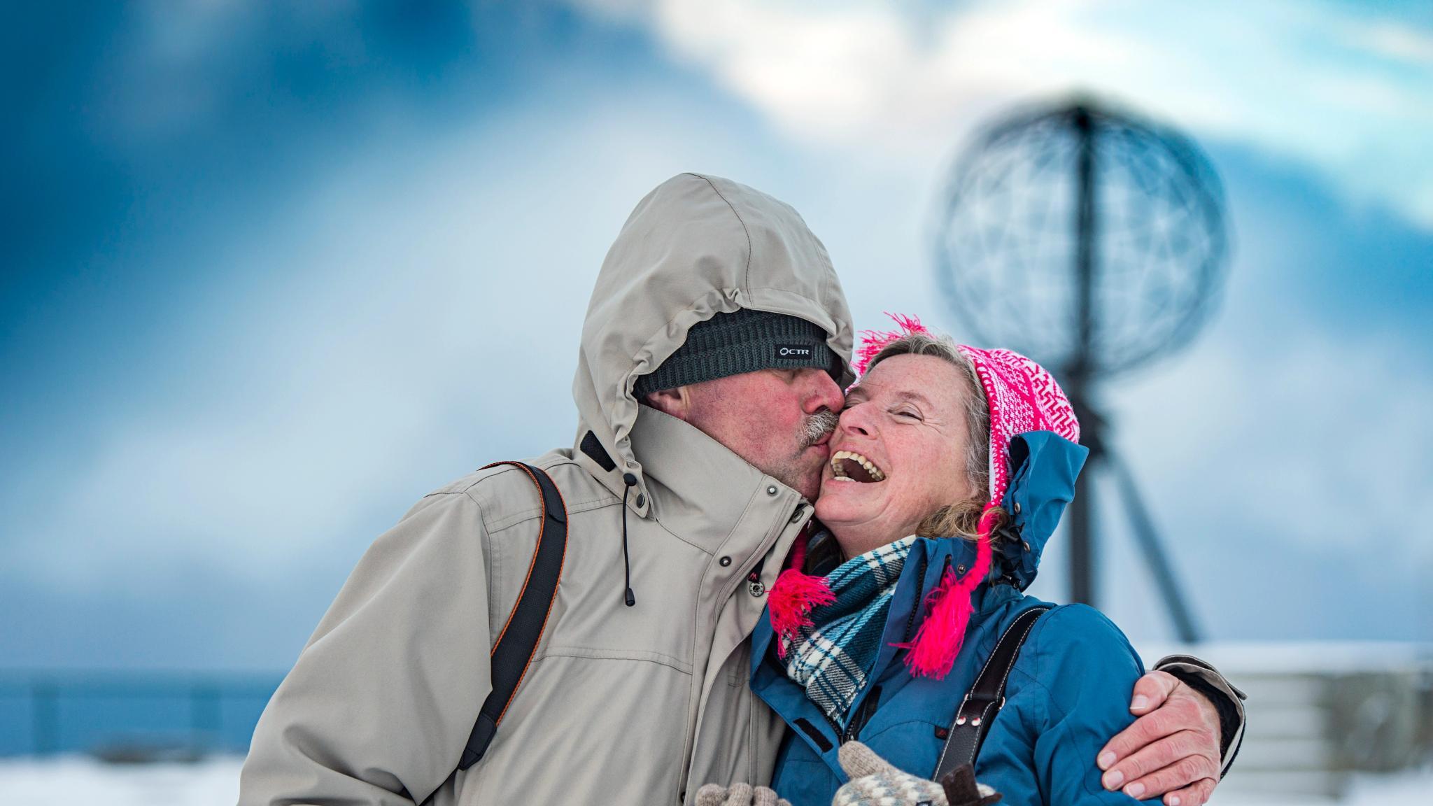Couple kissing in front of the North Cape Globe, at Magerøya