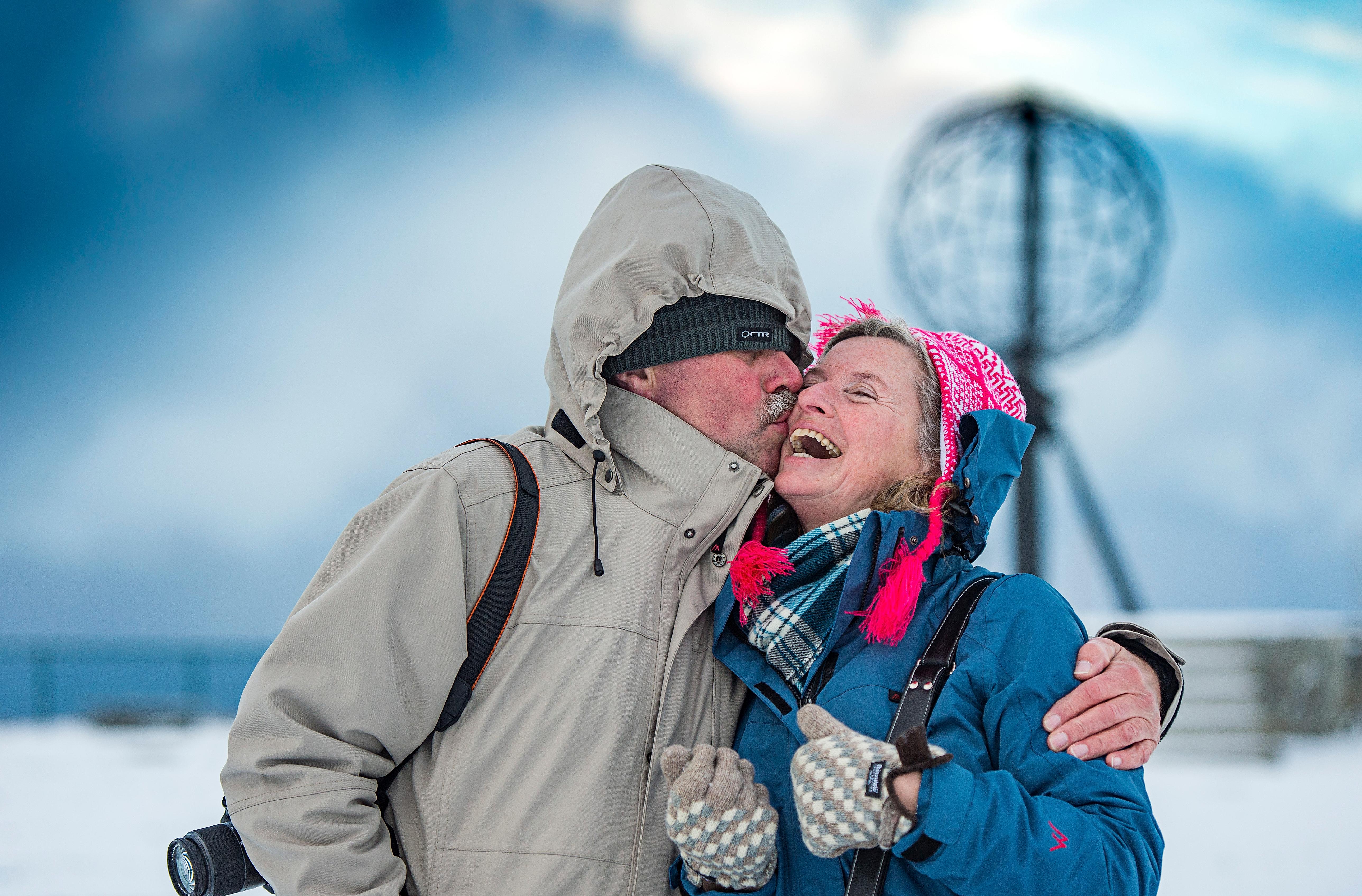 Couple kissing in front of the North Cape Globe, at Magerøya
