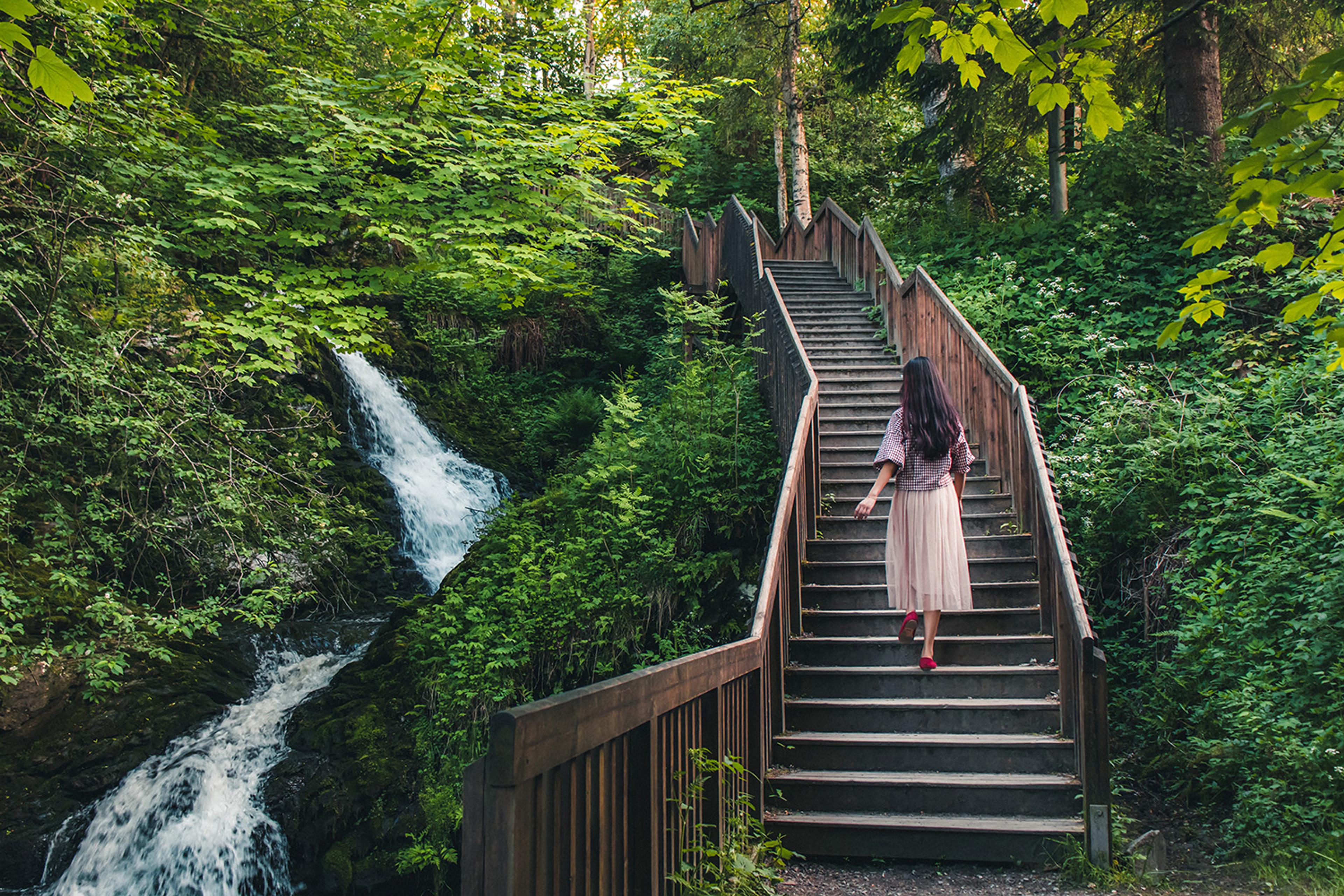 Woman walking stairs of the Iladalen trail, Trondheim, Norway