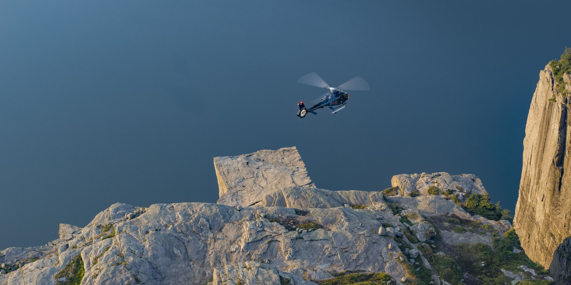 Helicopter flying over Preikestolen (The Pulpit Rock) in Fjord Norway
