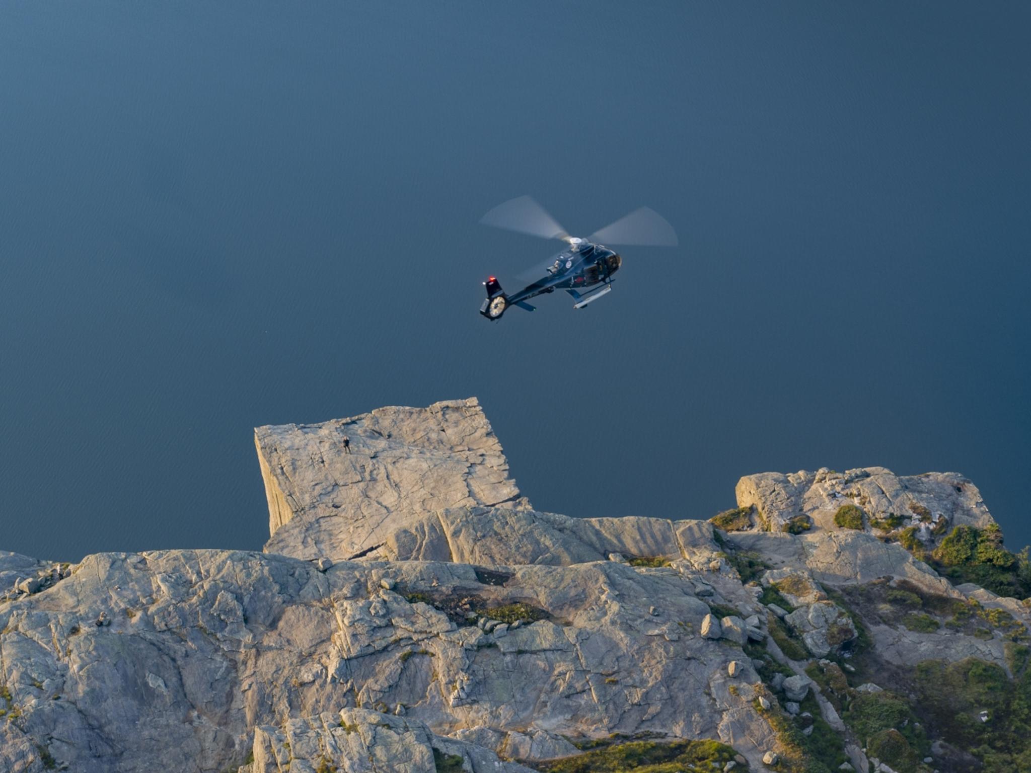 Helicopter flying over Preikestolen (The Pulpit Rock) in Fjord Norway