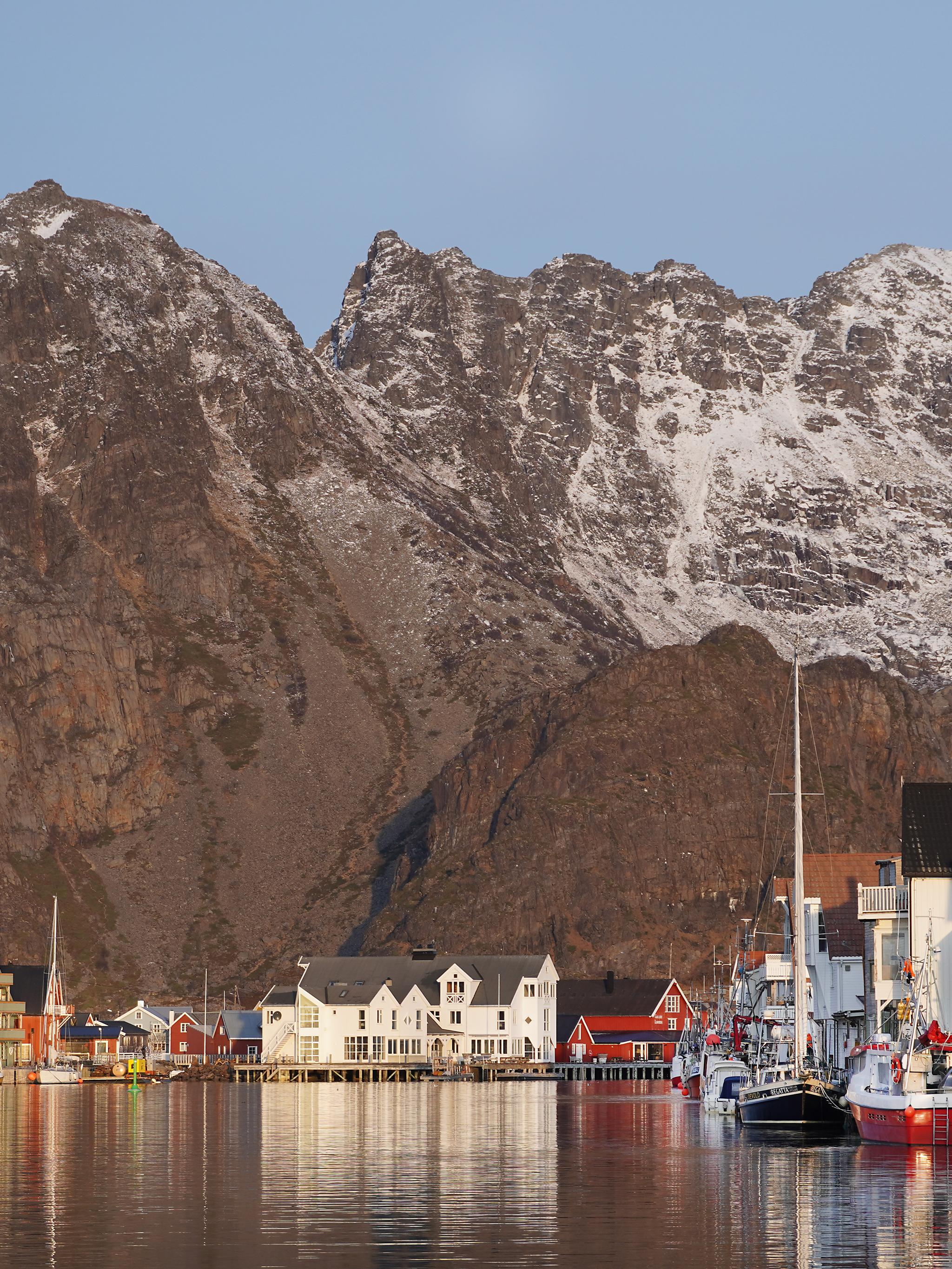 Fishing village at the foot of a big mountain.