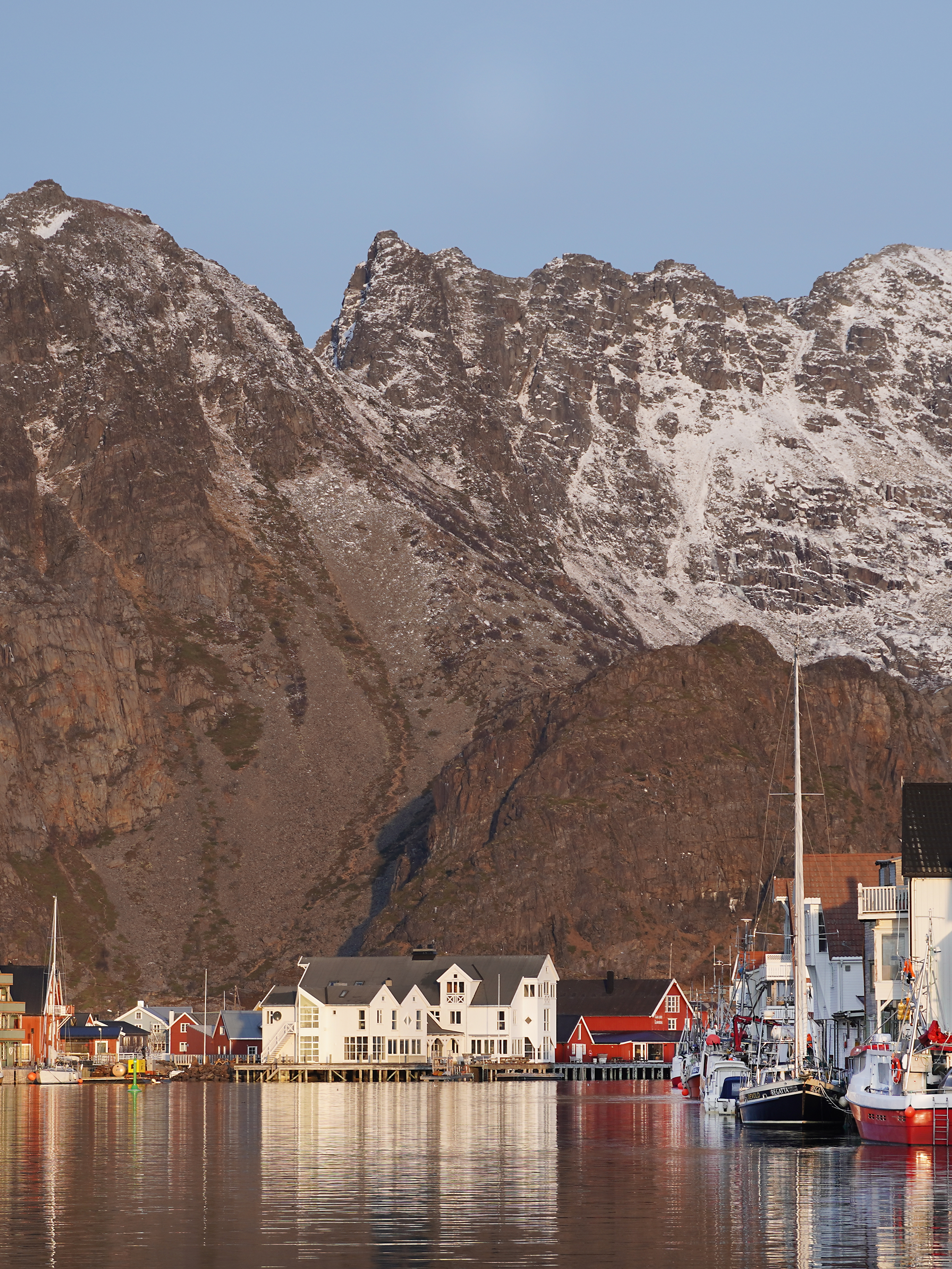 Fishing village at the foot of a big mountain.