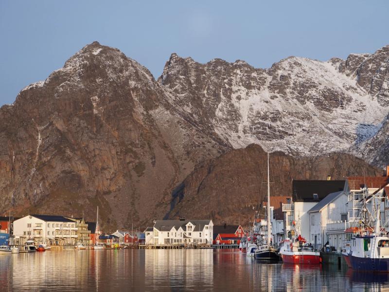 Fishing village at the foot of a big mountain.